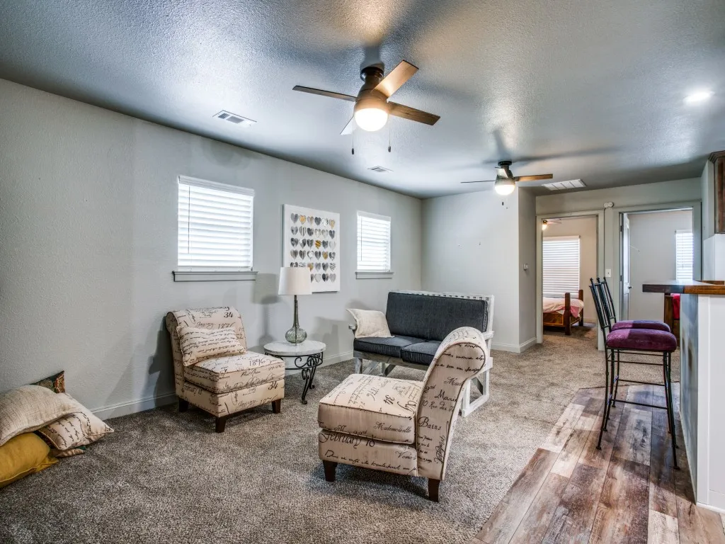 Second living quarters living area featuring hardwood / wood-style flooring, pendant lighting, a wealth of natural light
