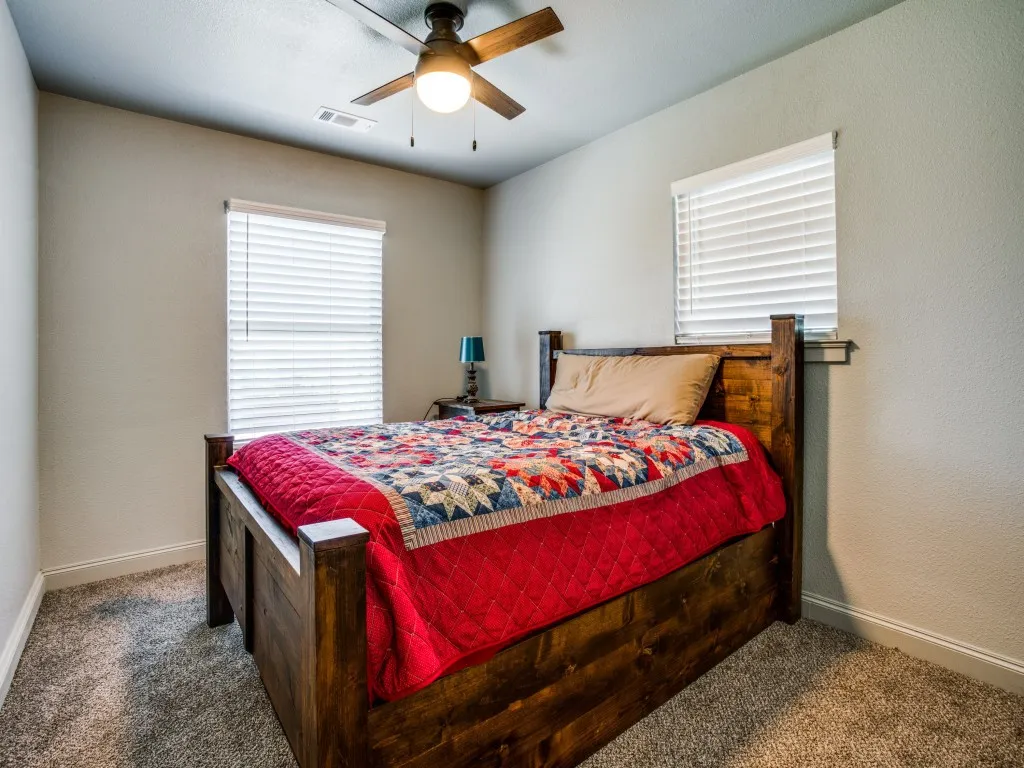 Second living quarters second bedroom featuring carpeted floors, great closet space, and  ceiling fan