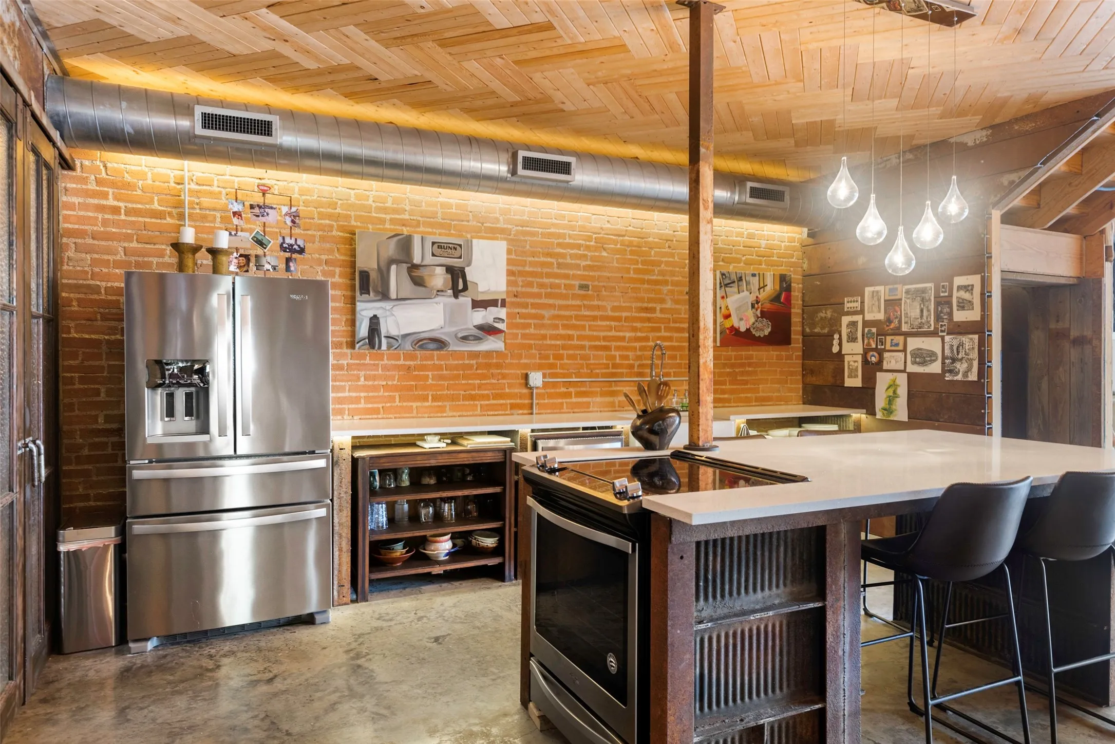Kitchen with decorative light fixtures, brick wall, appliances with stainless steel finishes, a kitchen bar, and wood ceiling