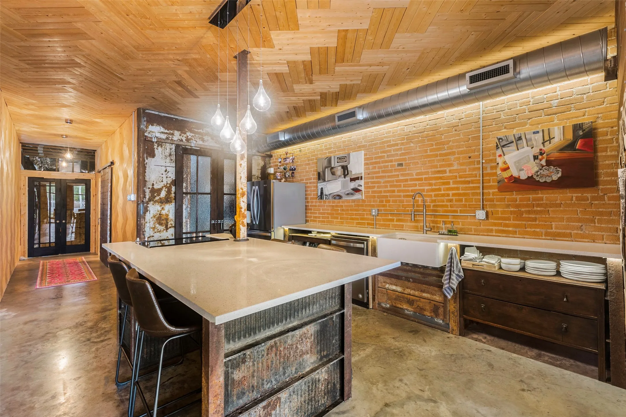 Kitchen with a kitchen island, wooden ceiling, sink, and french doors