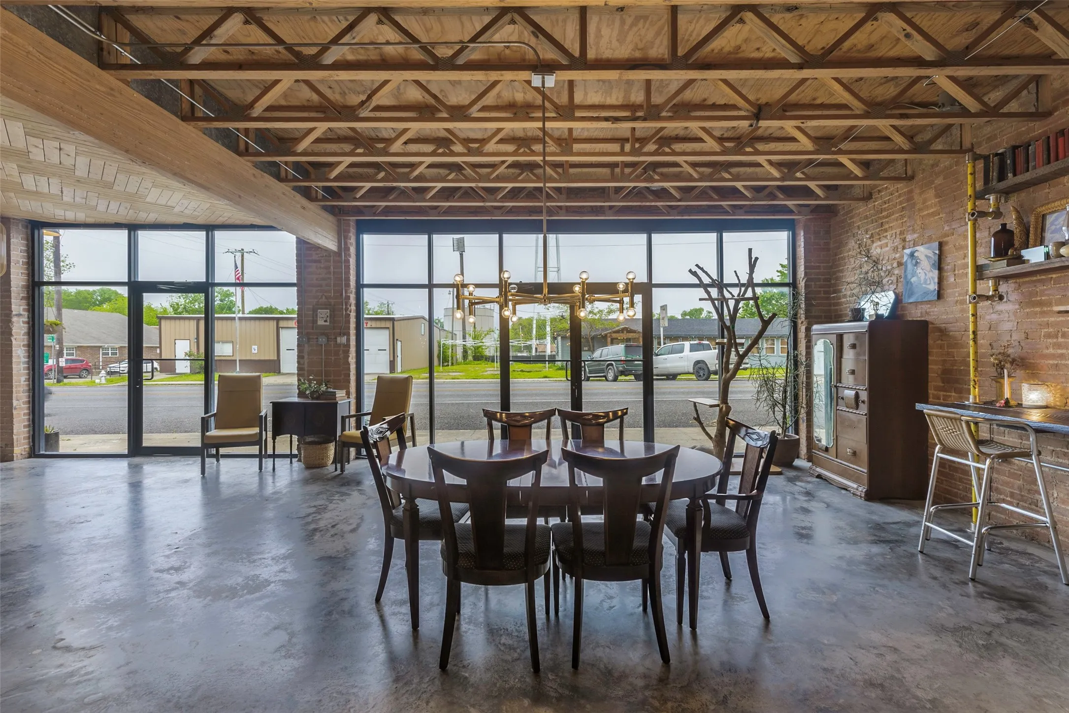 Dining space featuring brick wall and an inviting chandelier