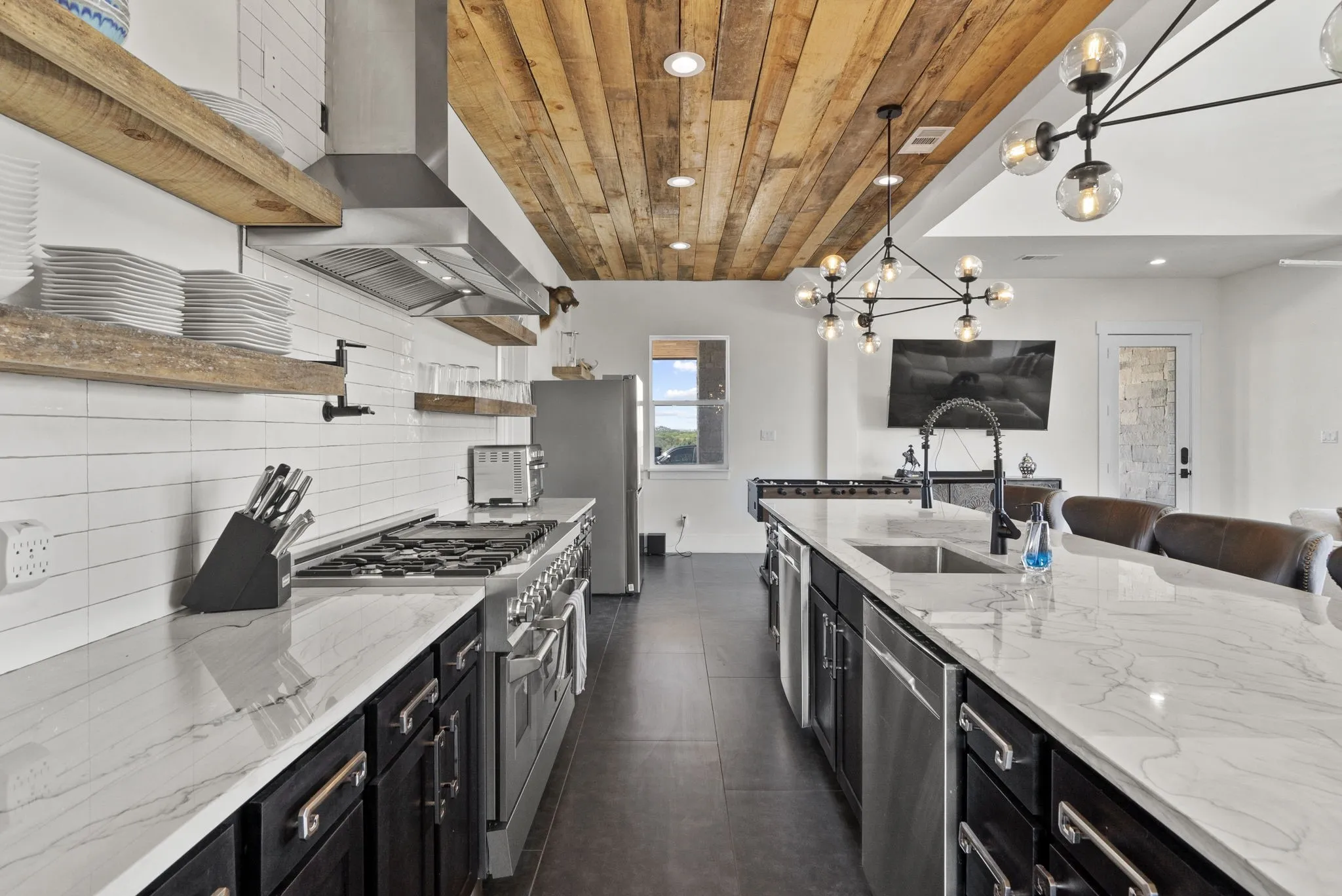 Two dishwashers. Two refrigerators. Commercial style propane range. Floating shelves.
