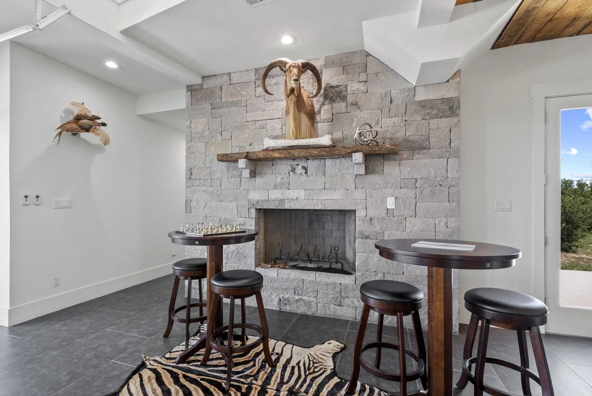 Pub style tables cozied up to the fireplace.