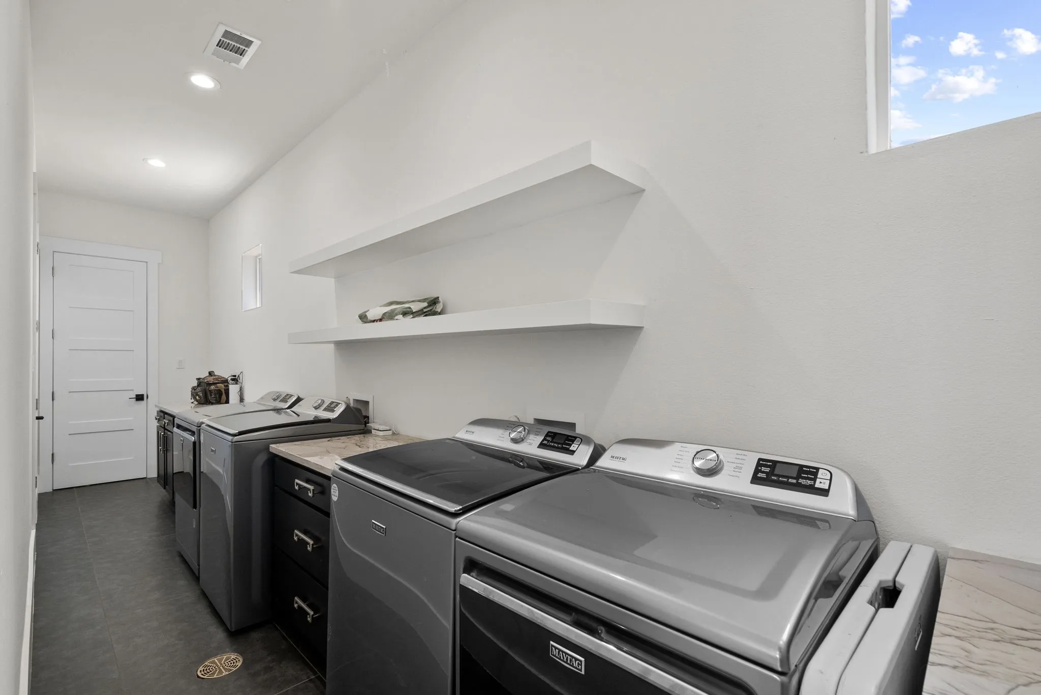 Beach towels and swimsuits are no match for this laundry room.
