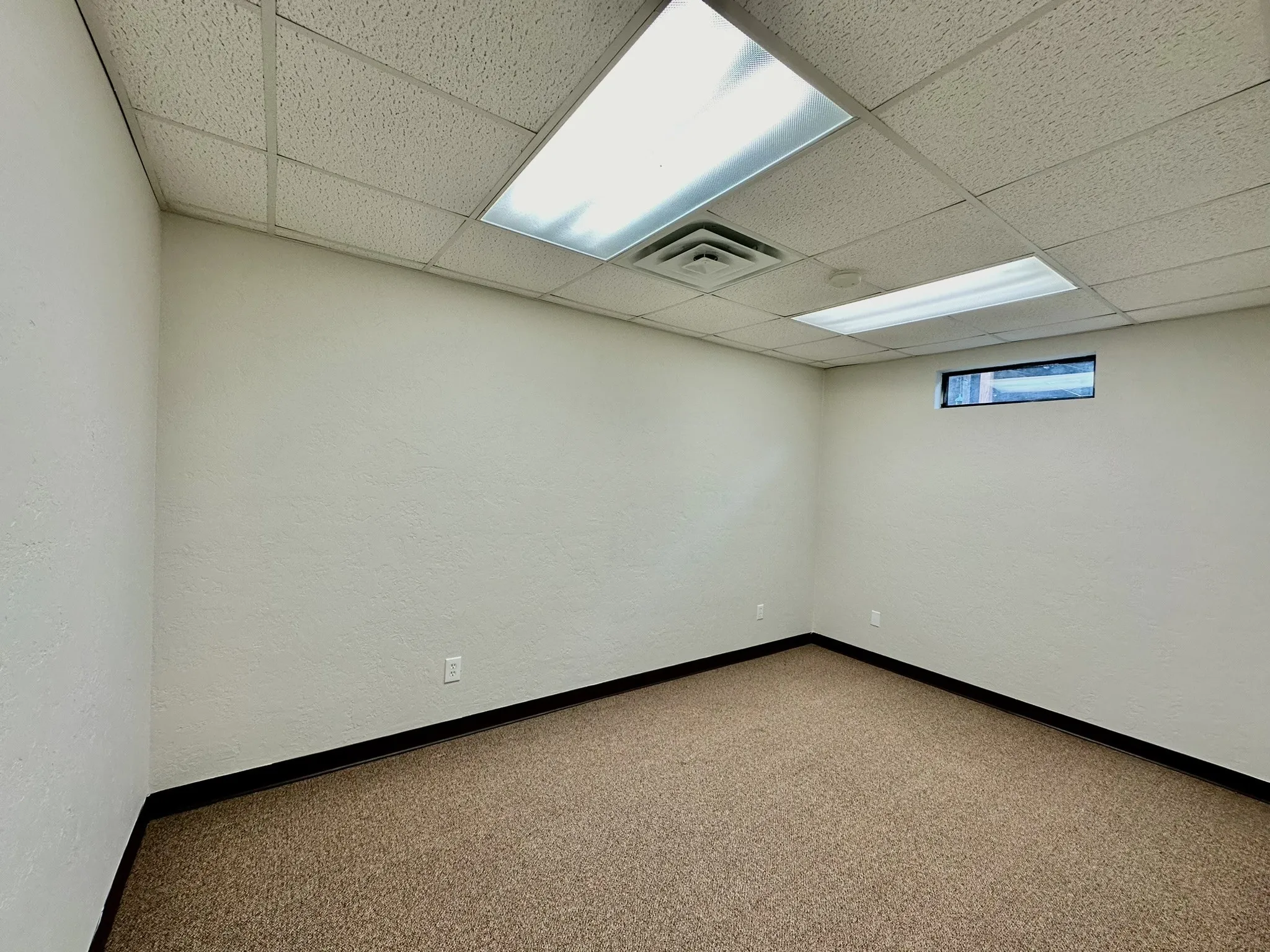 Carpeted empty room with a paneled ceiling