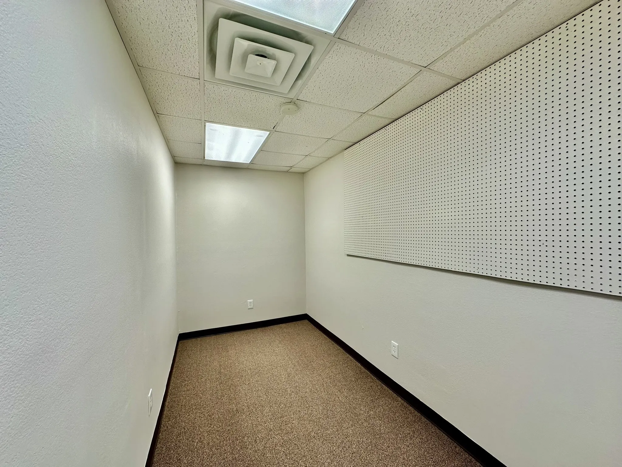 Unfurnished room featuring a paneled ceiling and carpet flooring