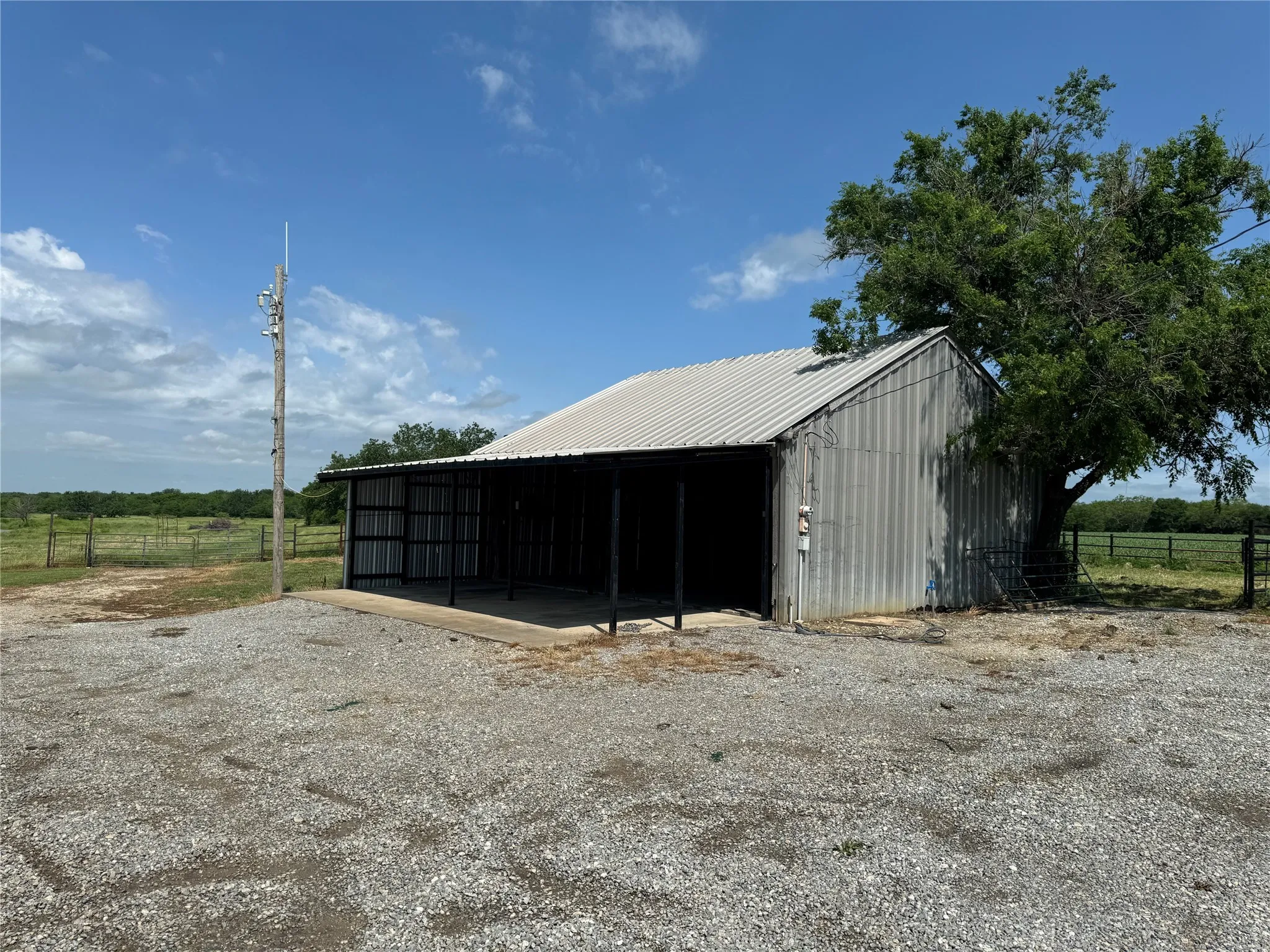 View of horse barn with a rural view and an outdoor structure