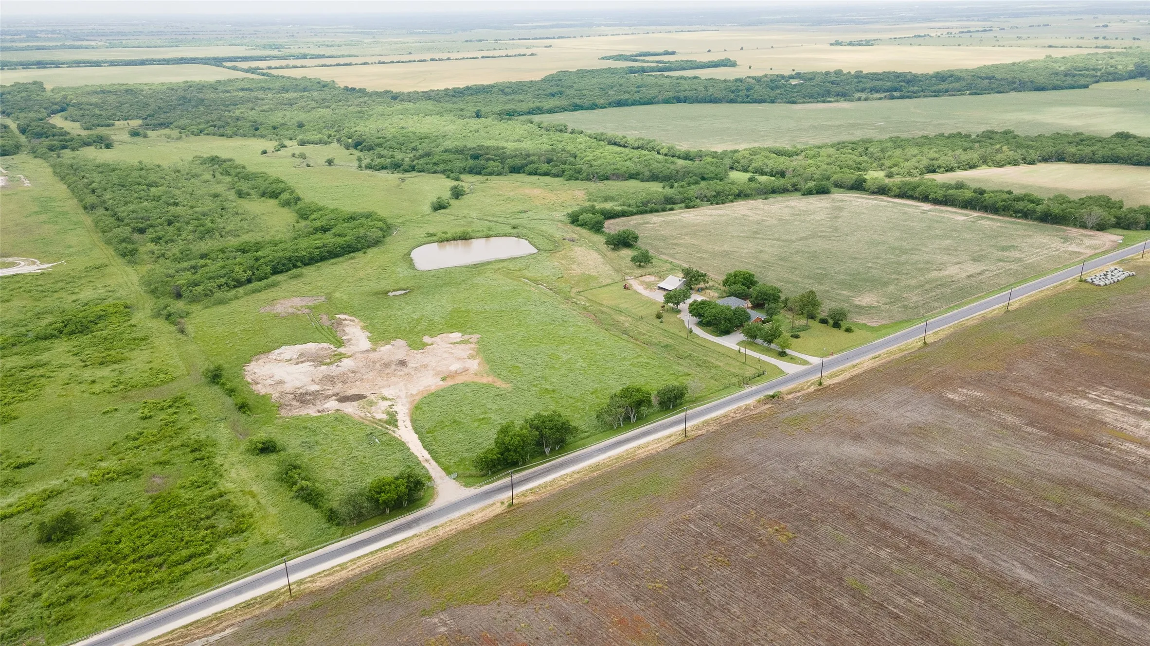 Birds eye view of property with a rural view and a water view