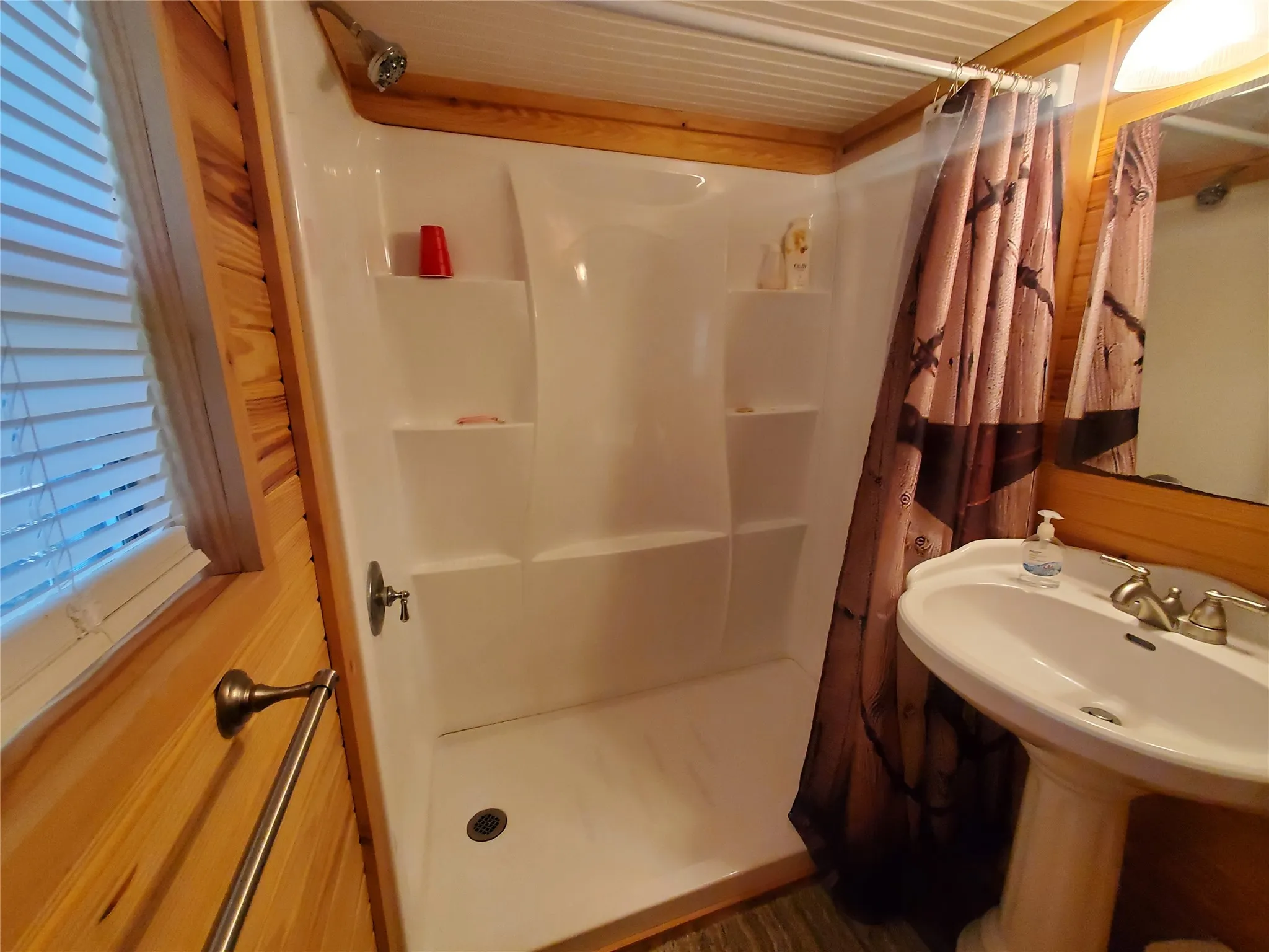 Bathroom with walk in shower and sink