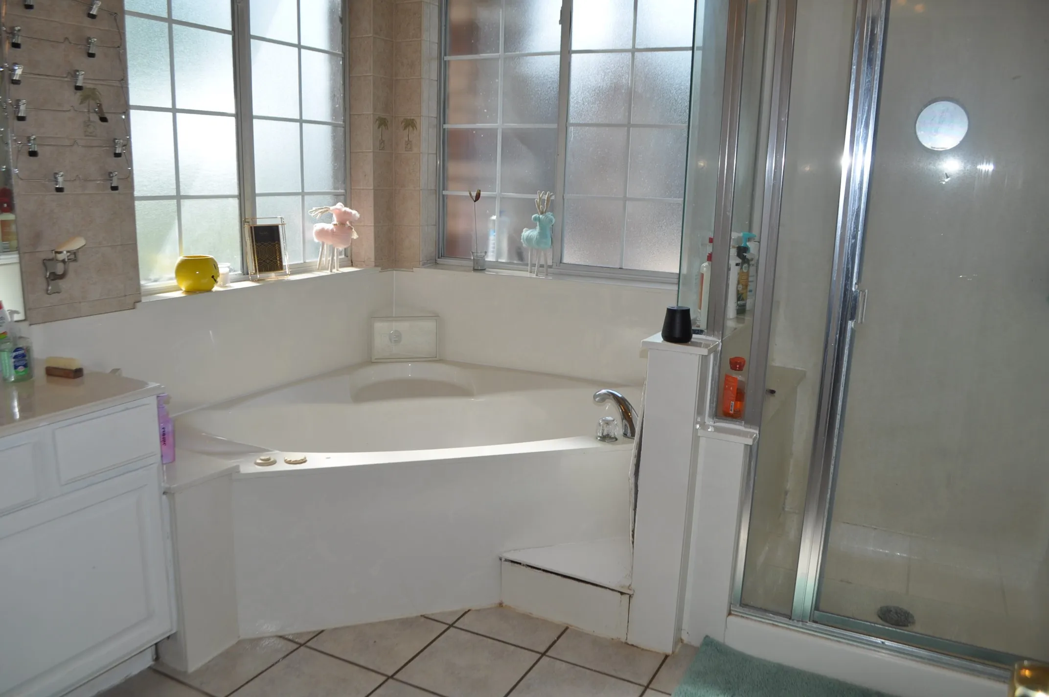 Bathroom featuring independent shower and bath, vanity, and tile floors