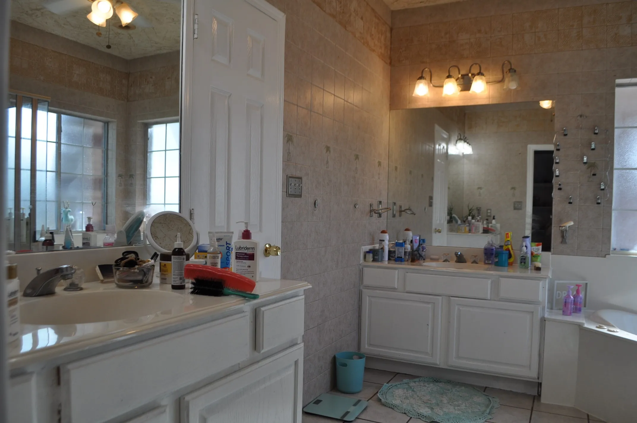 Bathroom featuring tile walls, a bath, tile floors, and large vanity