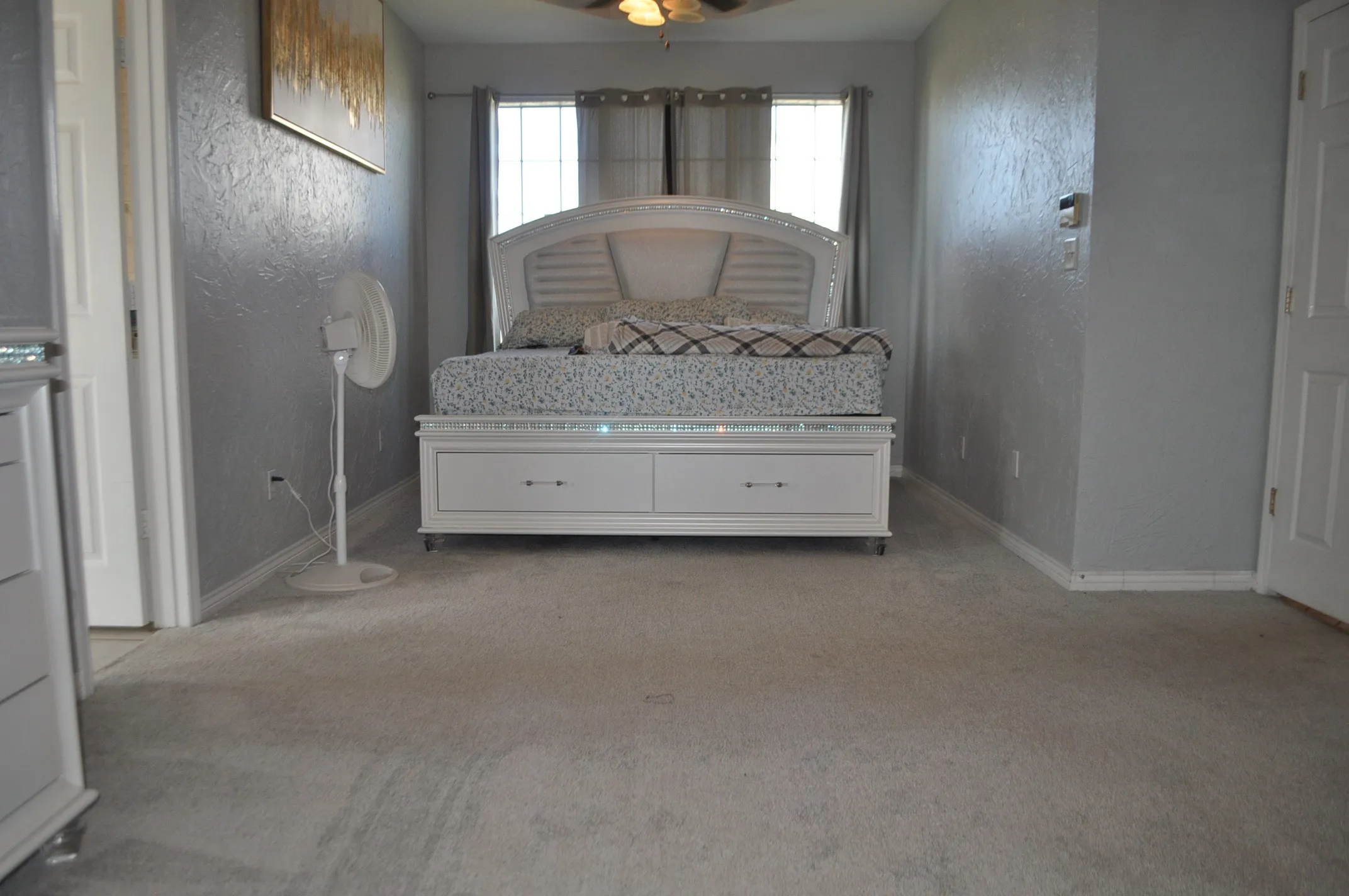 Unfurnished bedroom with carpet flooring and ceiling fan