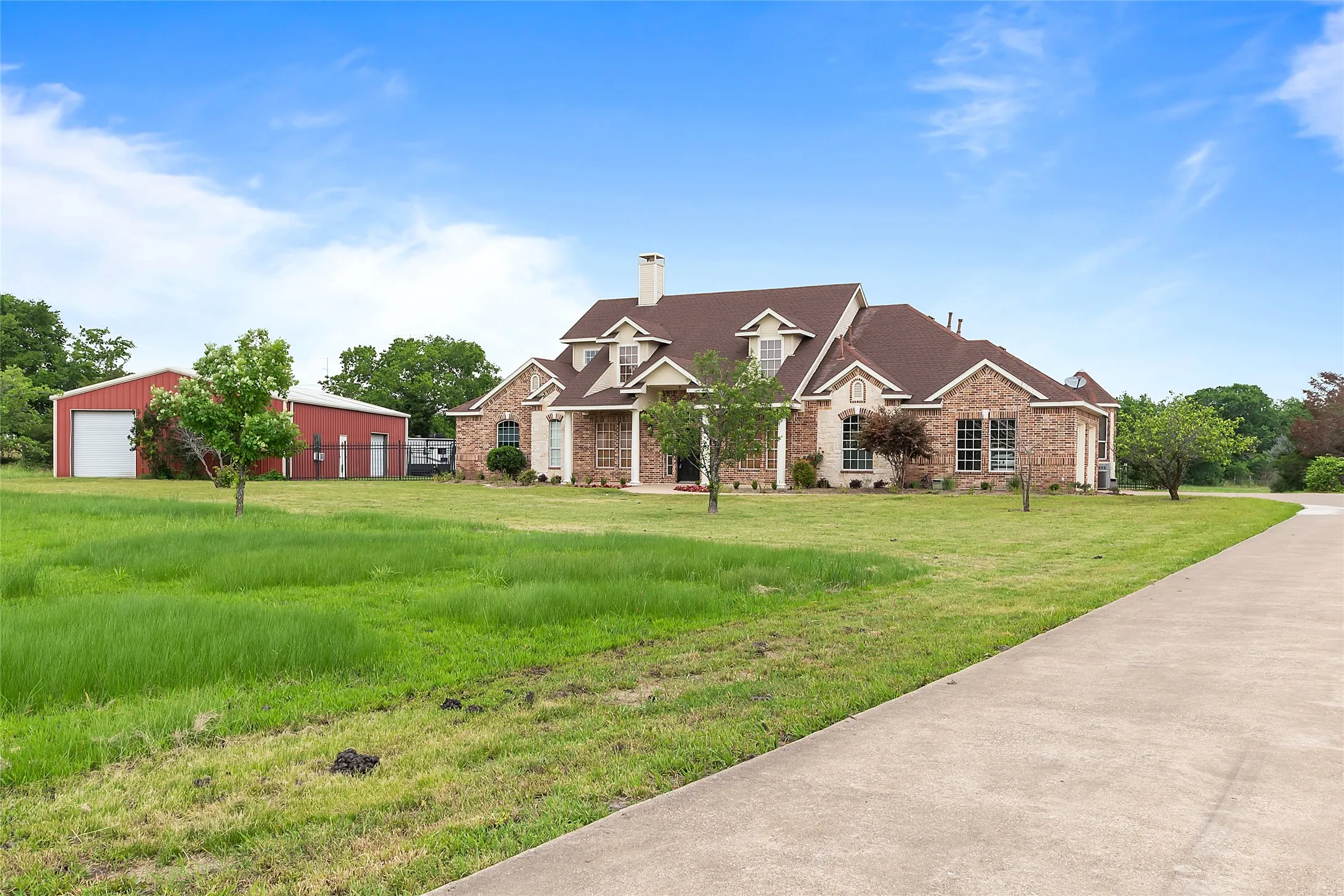 View of front of house featuring side garage & shared driveway