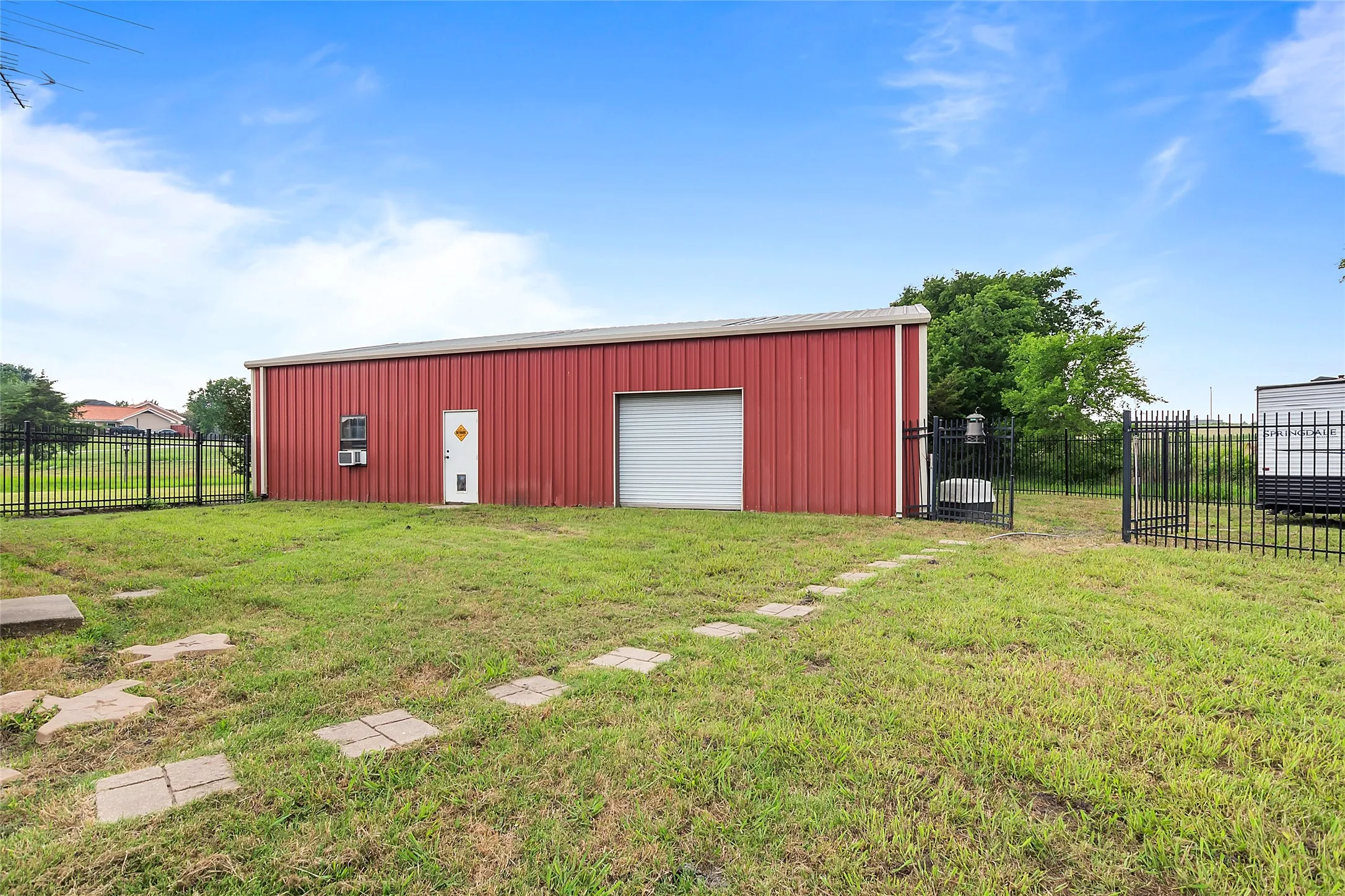 View of outdoor structure with a yard and a garage