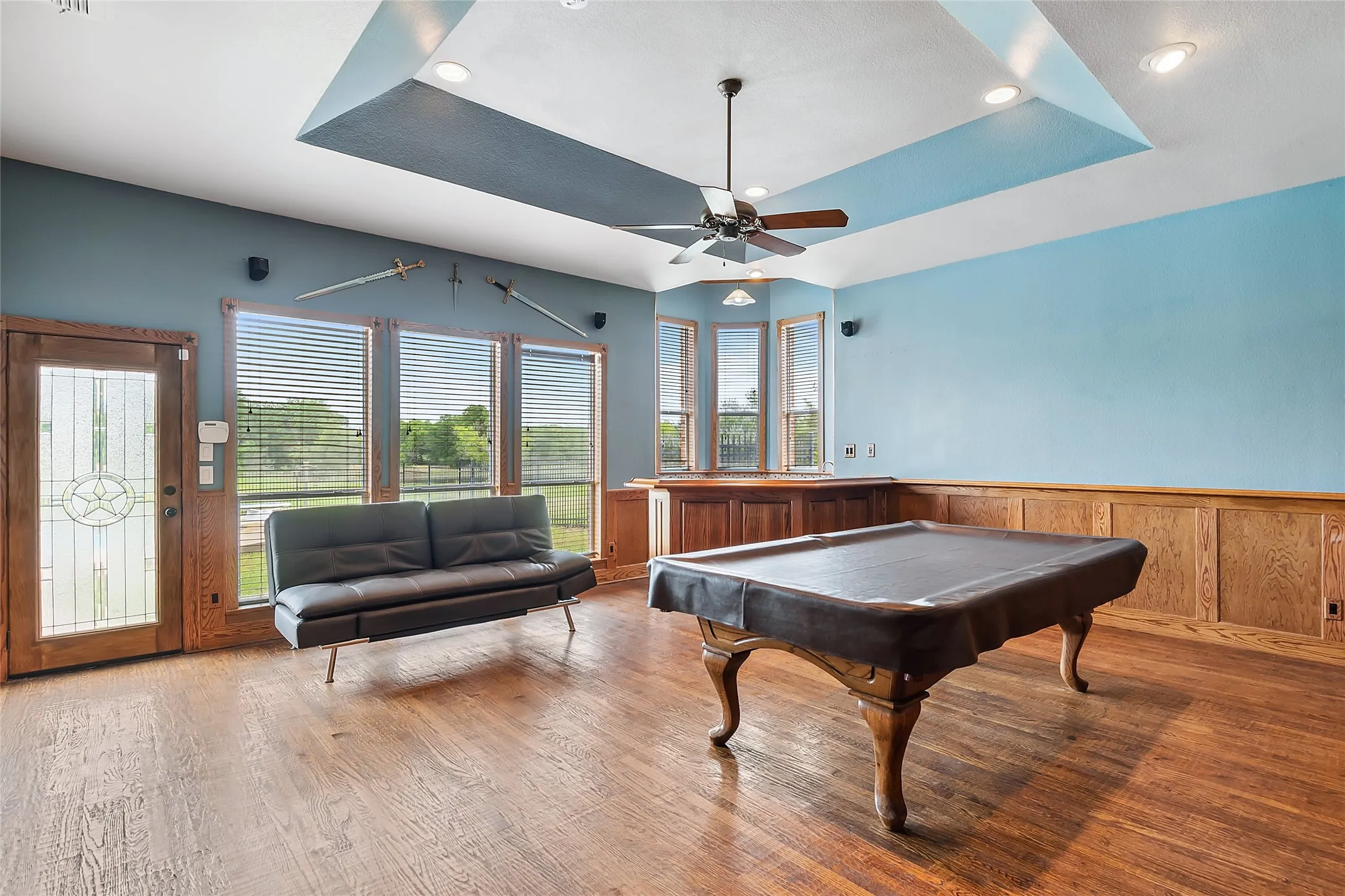 Game room featuring a raised ceiling, ceiling fan, hardwood  floors, and pool table