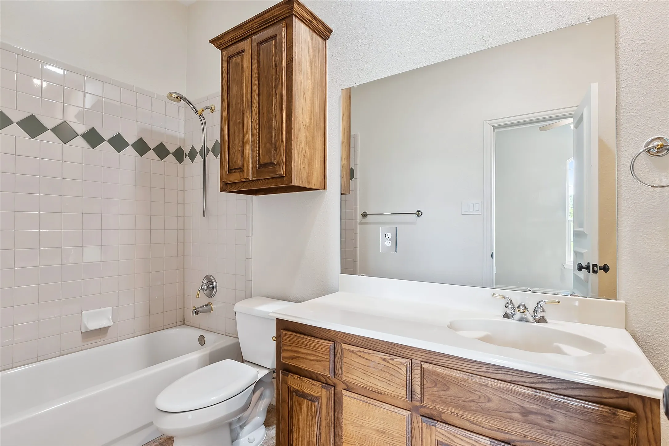 Full bathroom with tiled shower / bath, oversized vanity, and toilet
