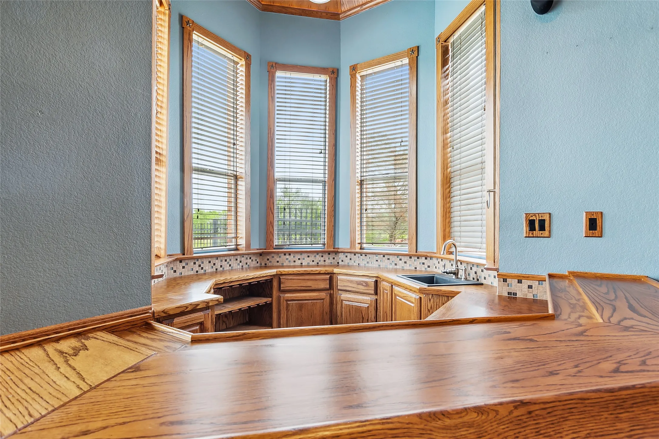 Kitchen featuring sink, a healthy amount of sunlight, and backsplash