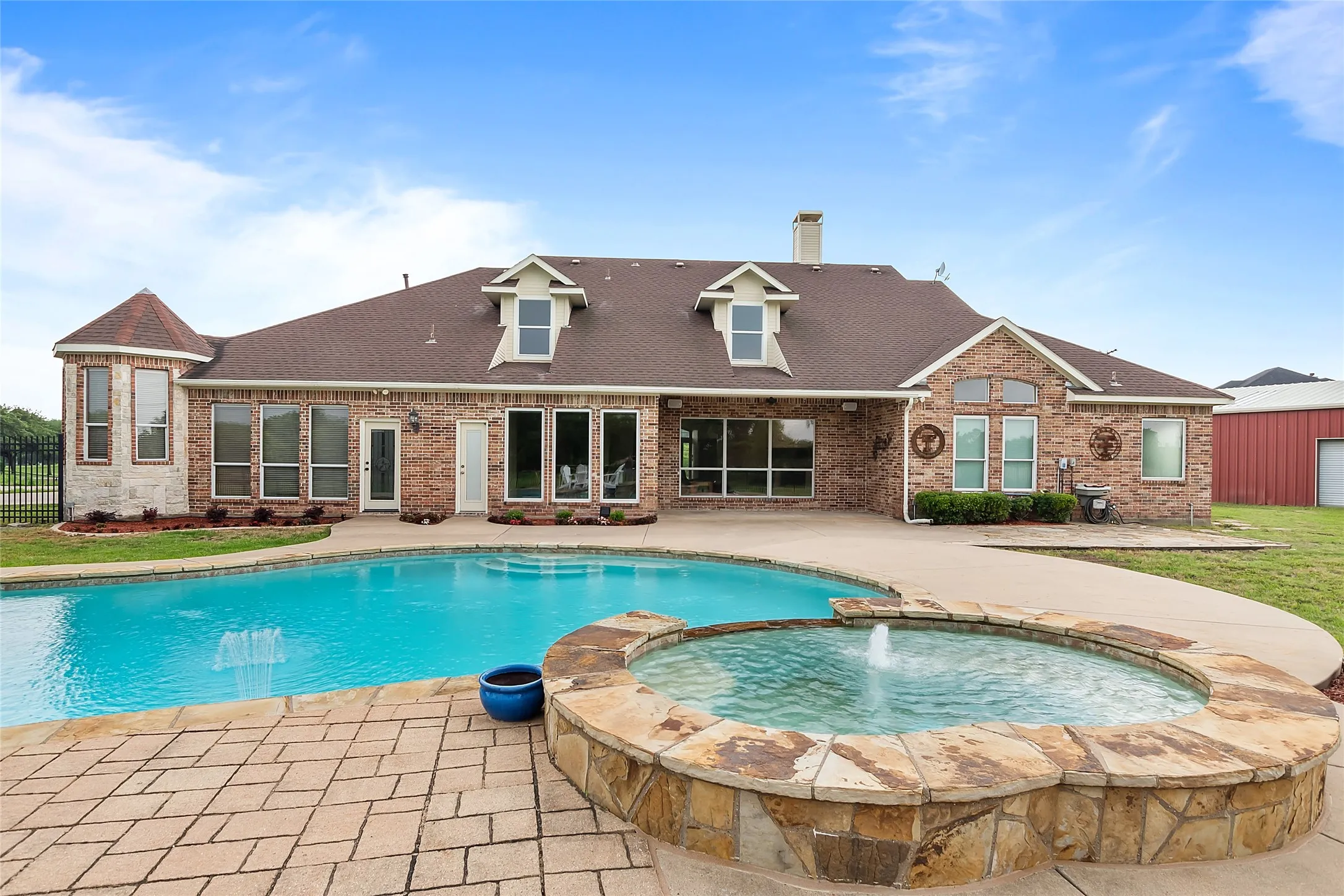 View of pool featuring a patio area, an in ground hot tub, and pool water feature
