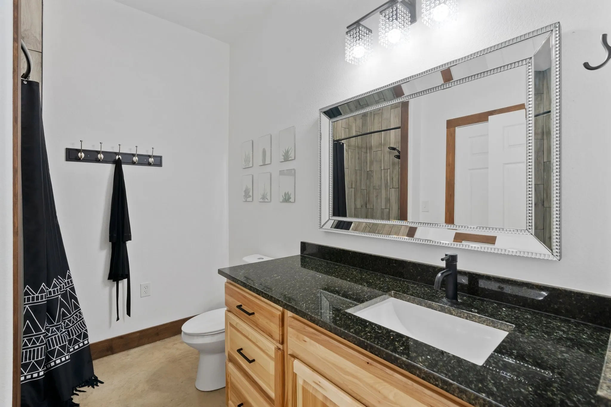 Bathroom featuring tile flooring, vanity, and toilet