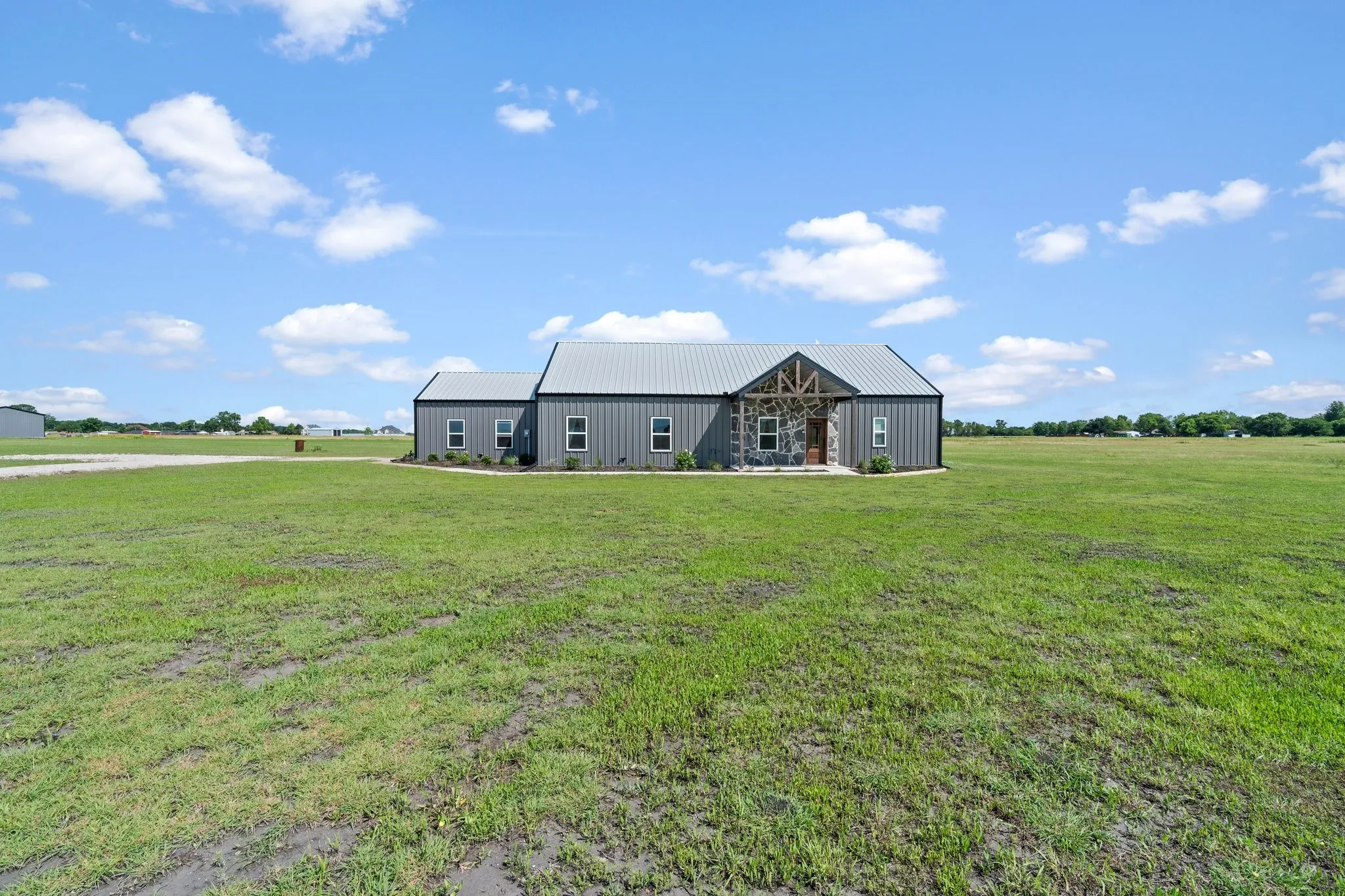 View of yard with an outdoor structure and a rural view