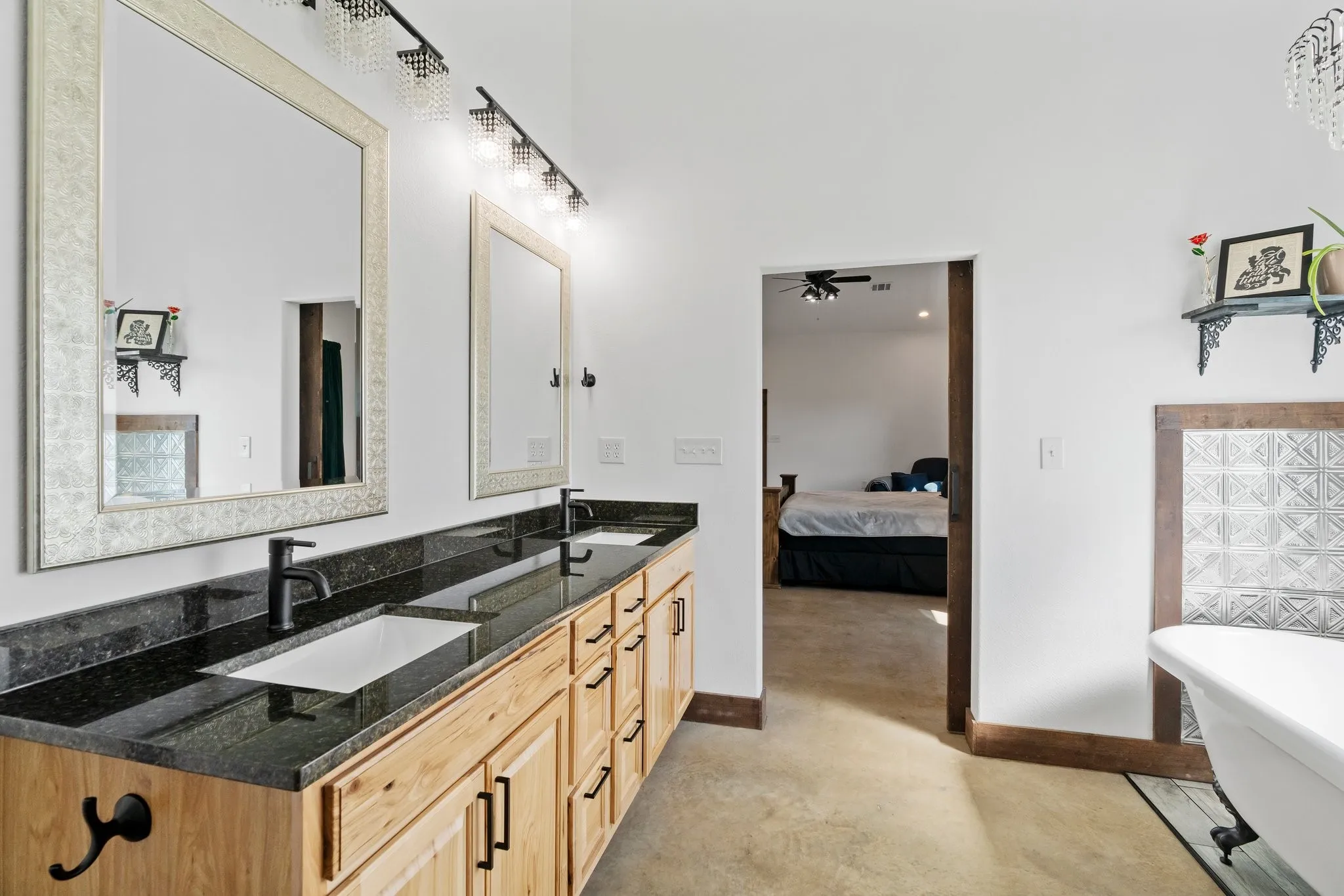 Bathroom with a bath to relax in, oversized vanity, dual sinks, and ceiling fan