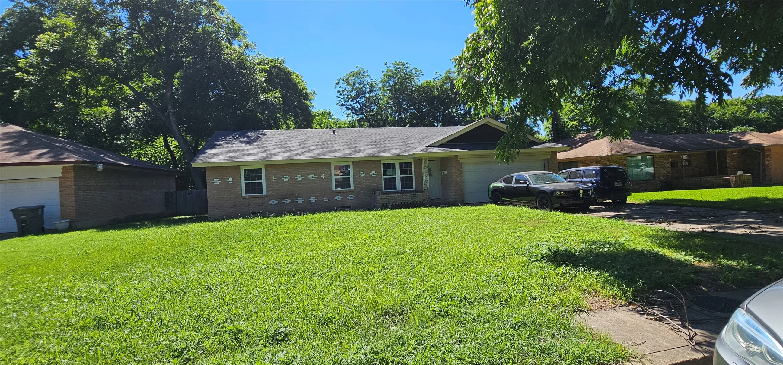 Single story home featuring a garage and a front yard