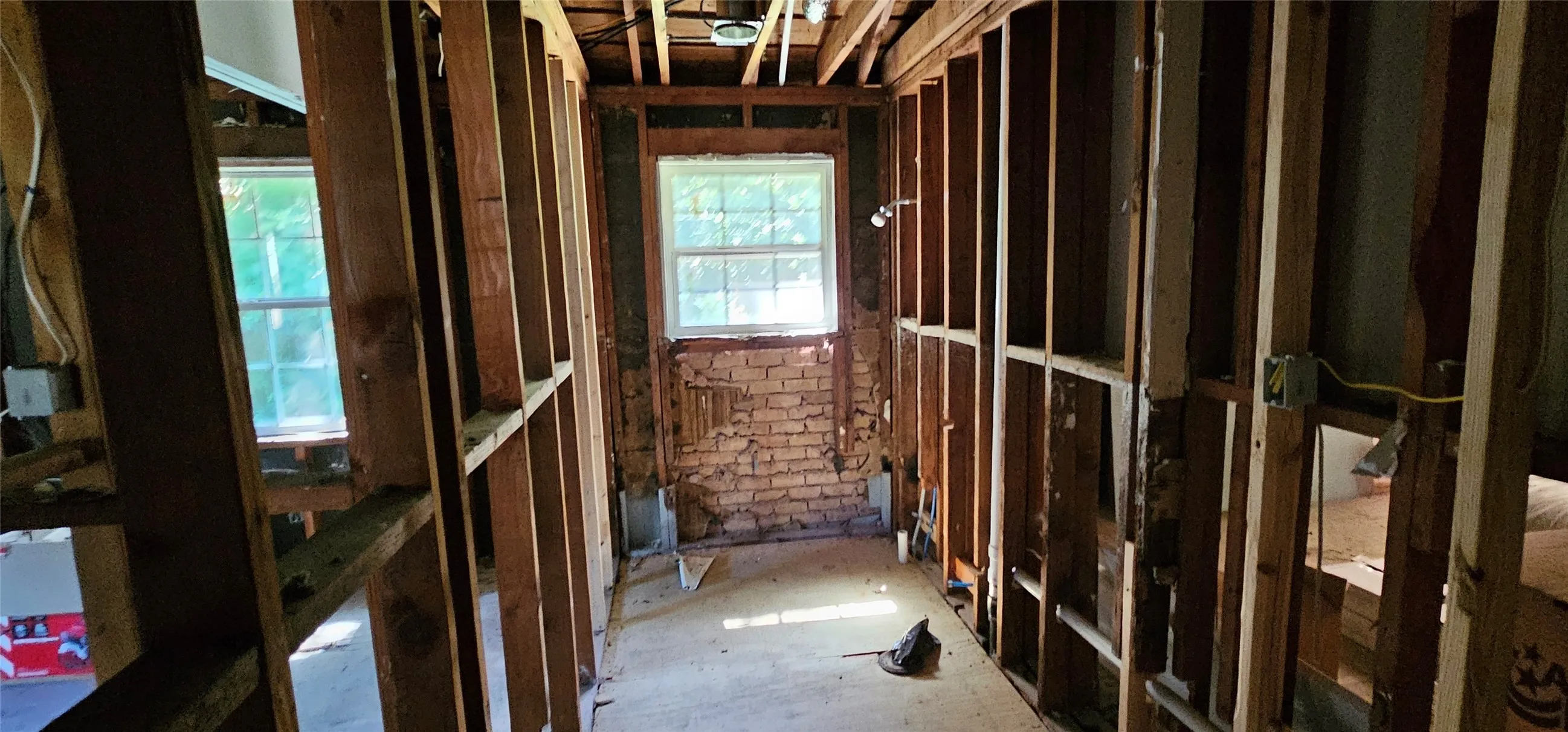 Miscellaneous room featuring brick wall