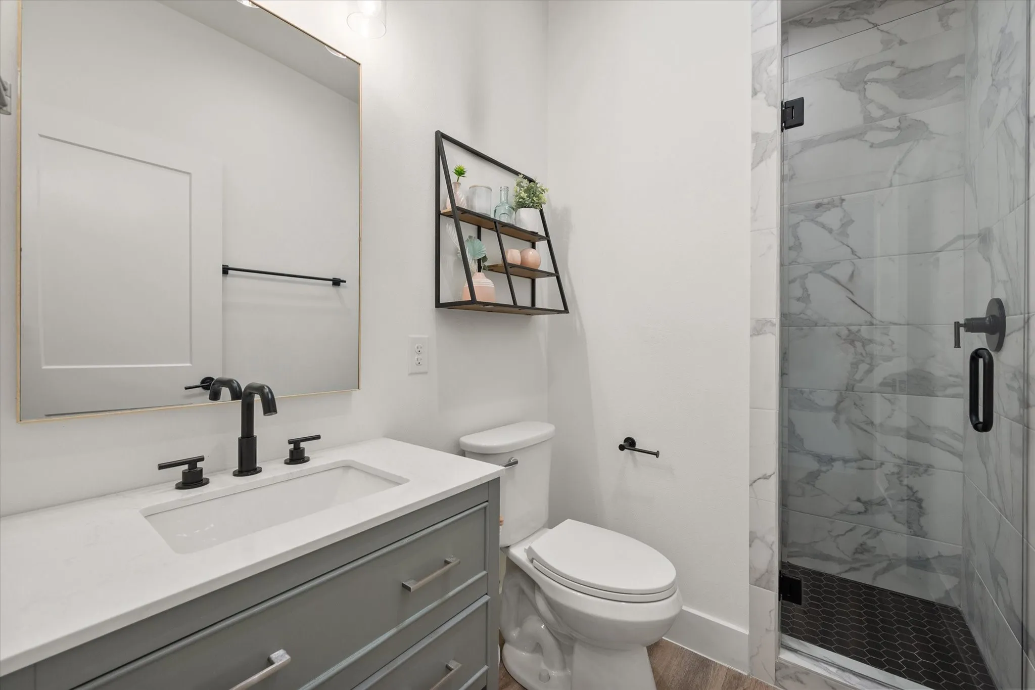 Bathroom with a shower with shower door, oversized vanity, hardwood / wood-style flooring, and toilet