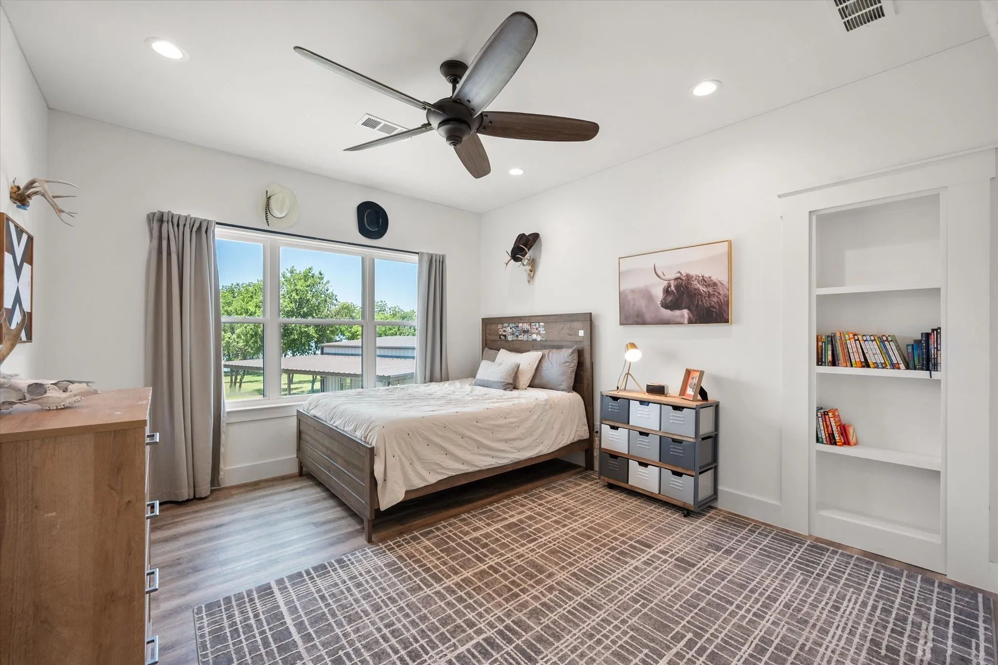 Bedroom featuring ceiling fan and wood-type flooring