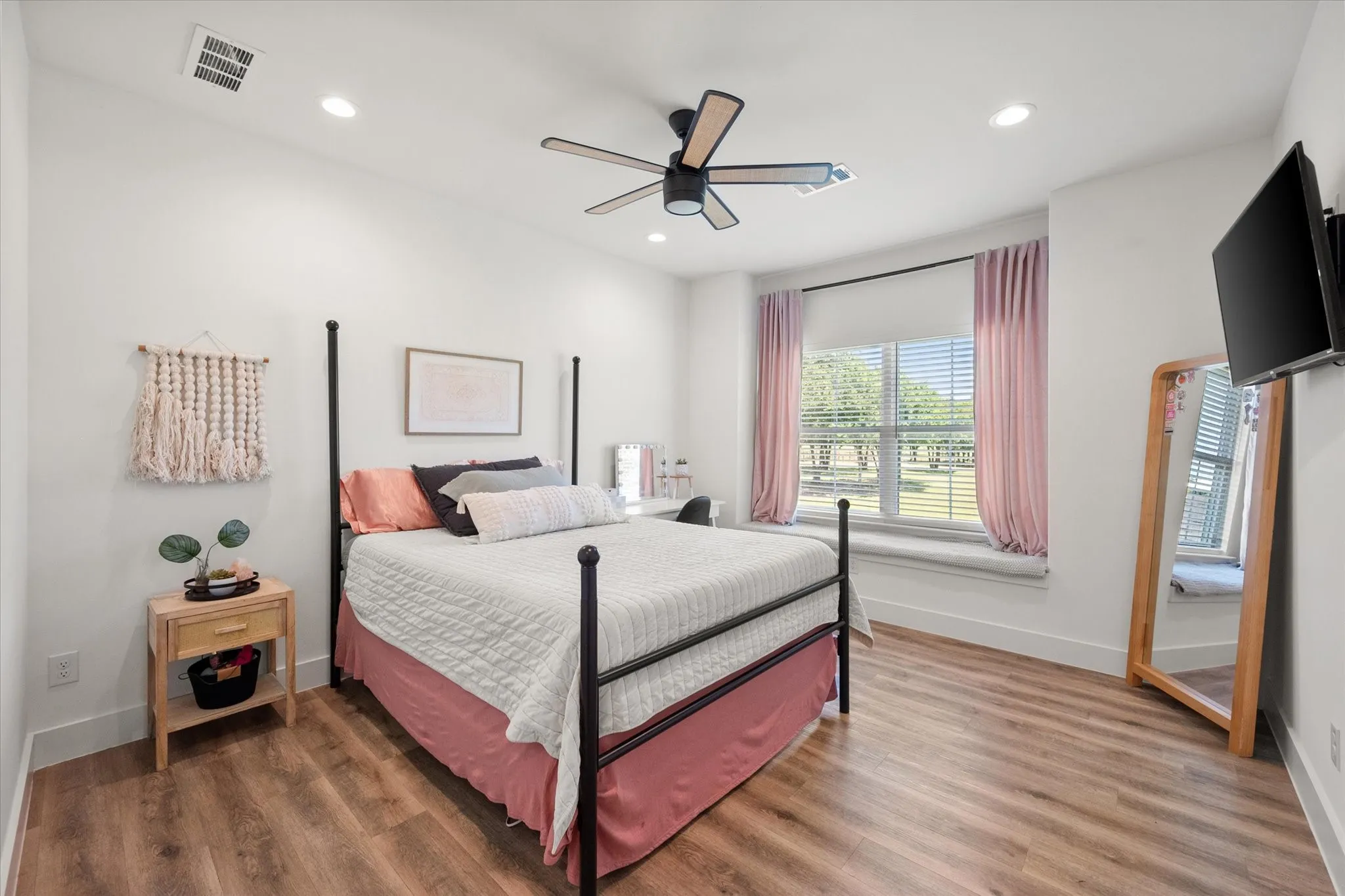 Bedroom featuring ceiling fan and hardwood / wood-style flooring