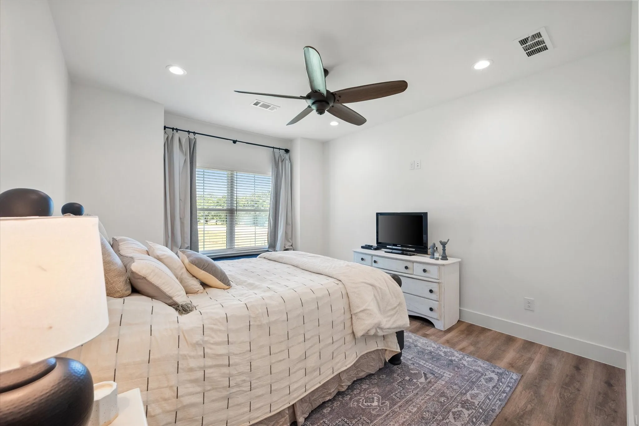 Bedroom featuring wood-type flooring and ceiling fan