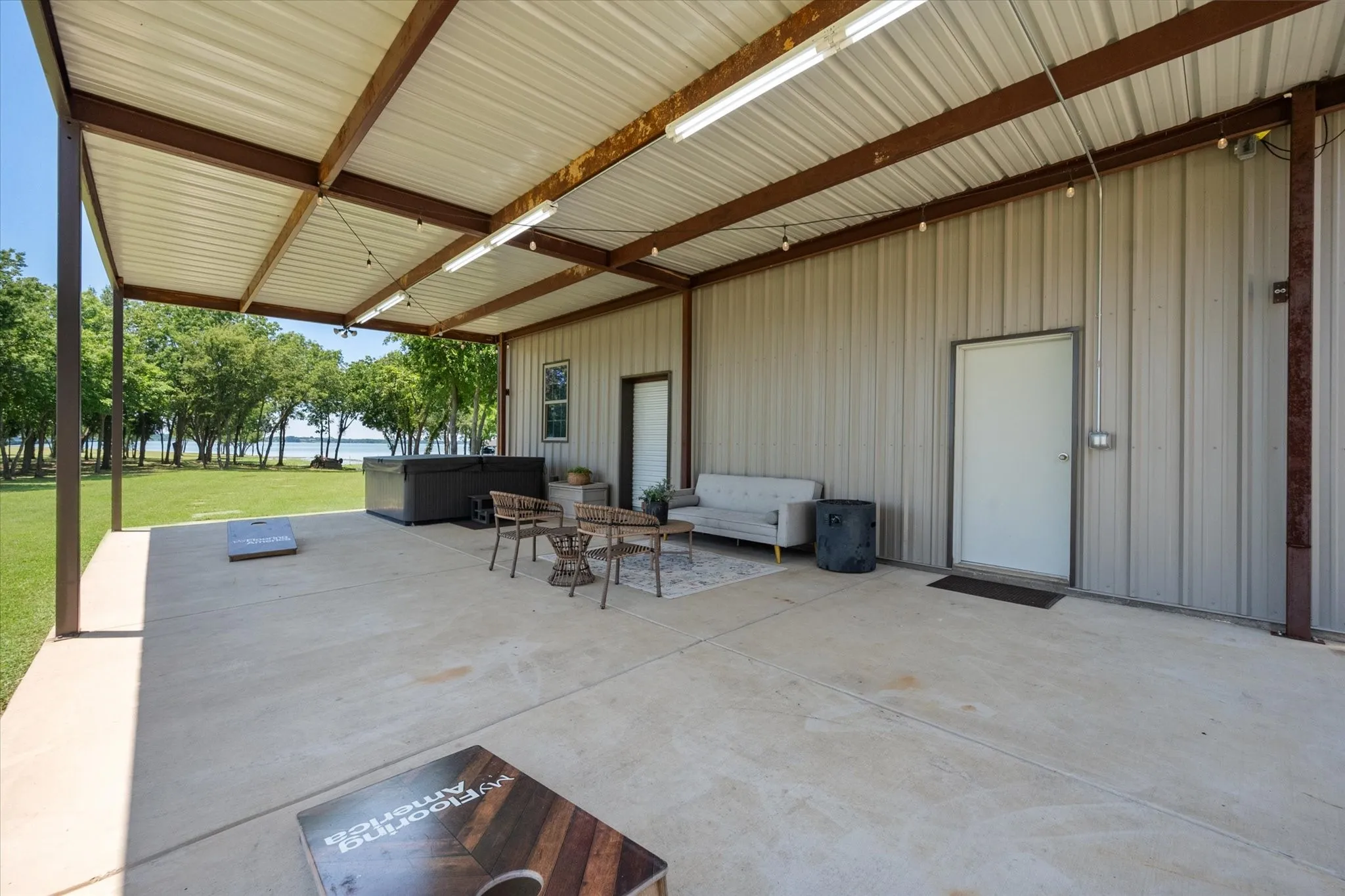 View of patio with hot tub off of workshop