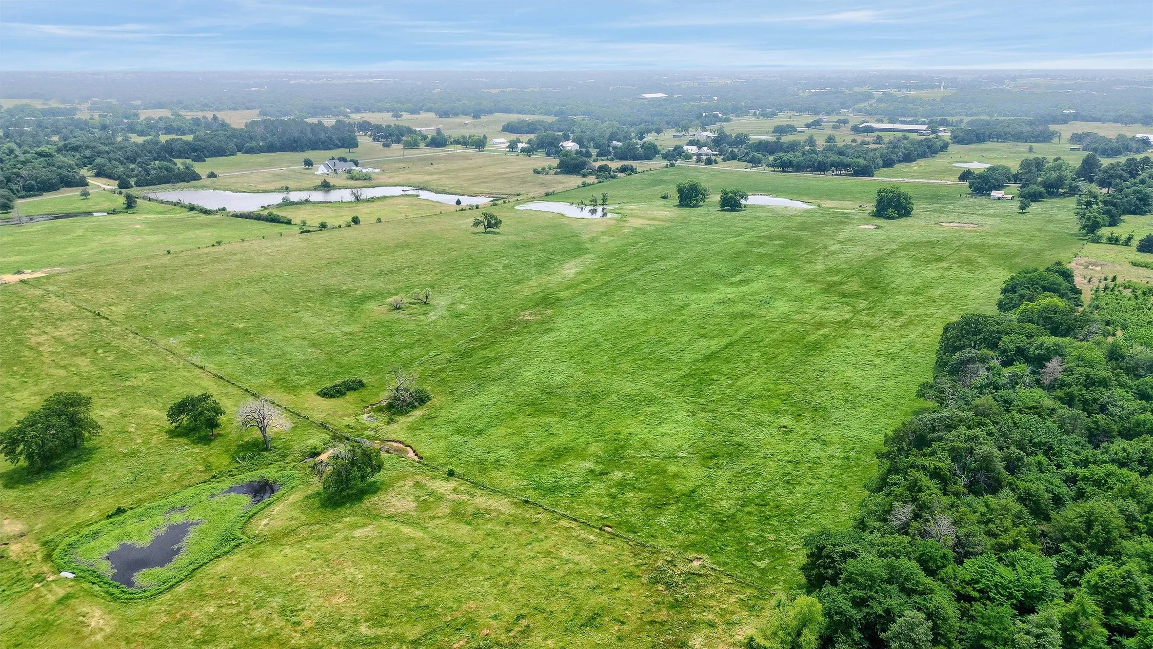 Drone / aerial view with a water view and a rural view