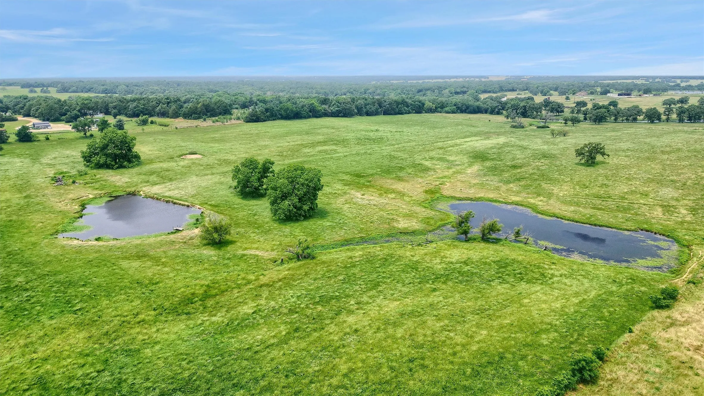 Birds eye view of property with a water view and a rural view