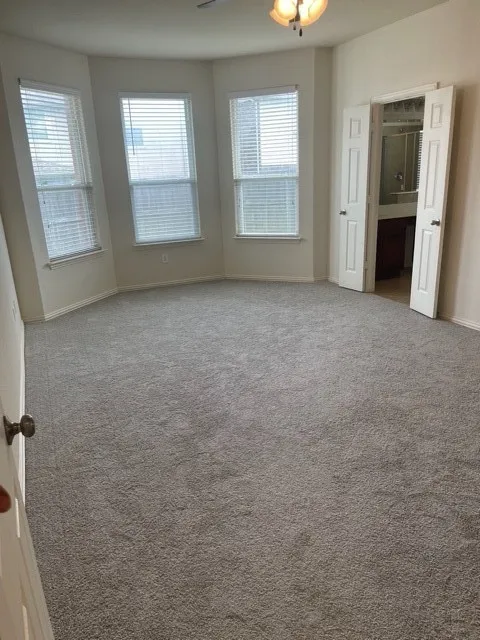 Carpeted empty room with a wealth of natural light