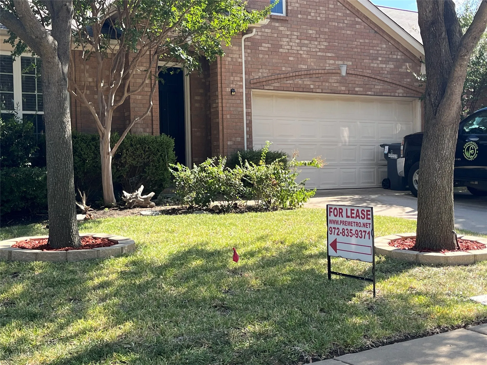 View of side of home with a garage and a lawn
