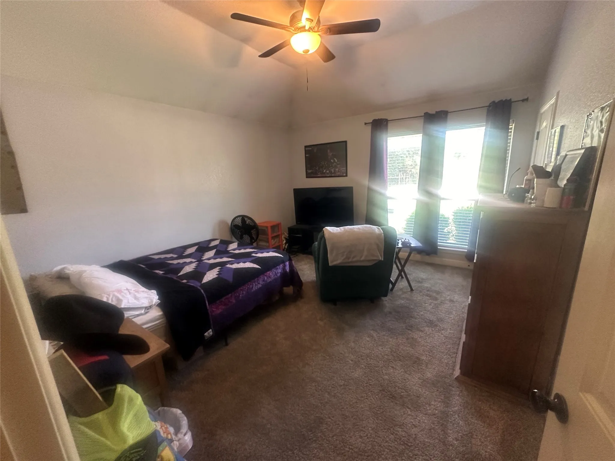 Bedroom featuring carpet flooring, ceiling fan, and lofted ceiling