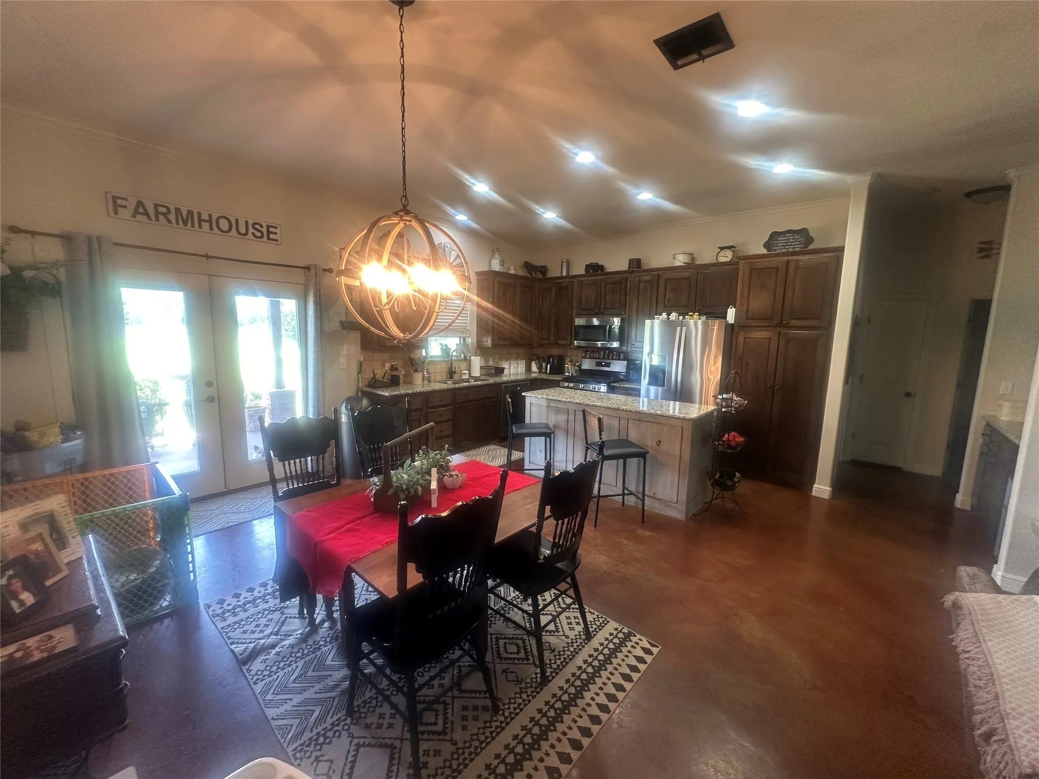 Dining area with a notable chandelier and french doors