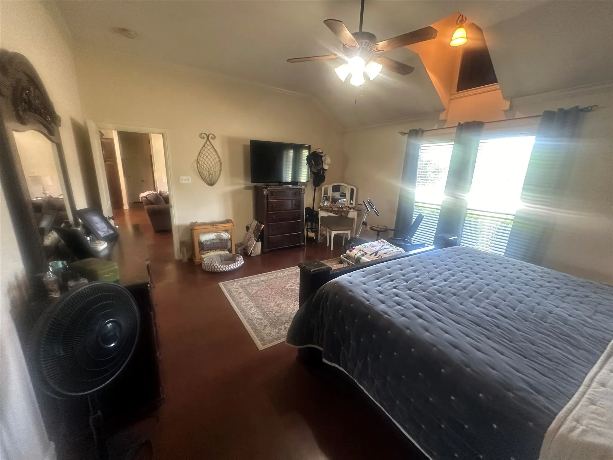 Bedroom featuring vaulted ceiling, wood-type flooring, ceiling fan, and crown molding