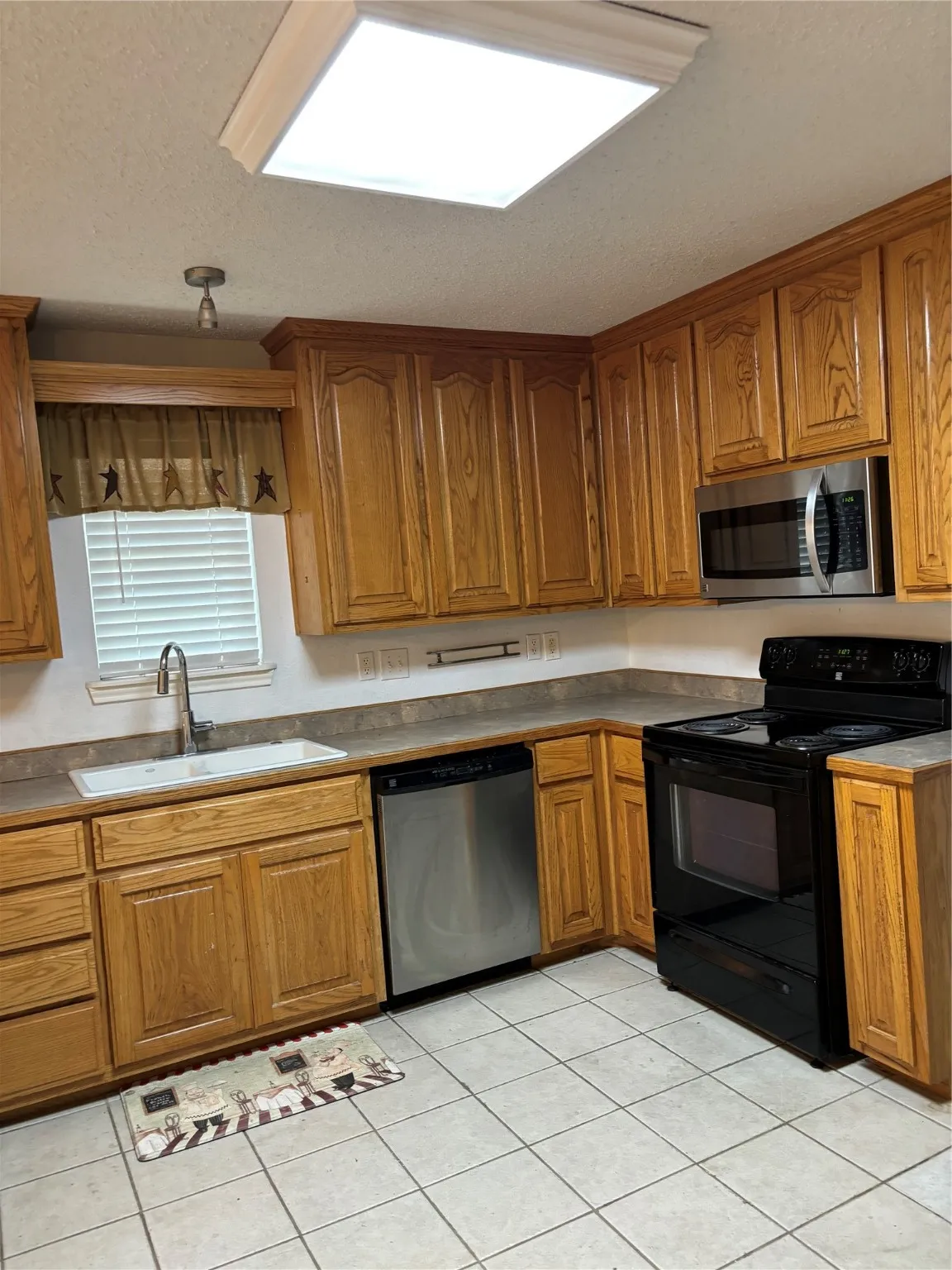 Lots of Hardwood cabinets, Range, fridge, microwave & dishwasher