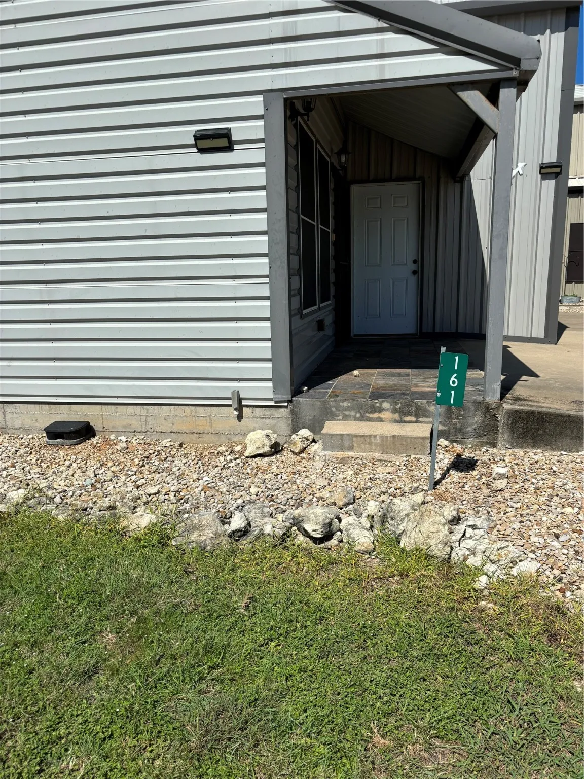 Side of house looking to door into port garage.