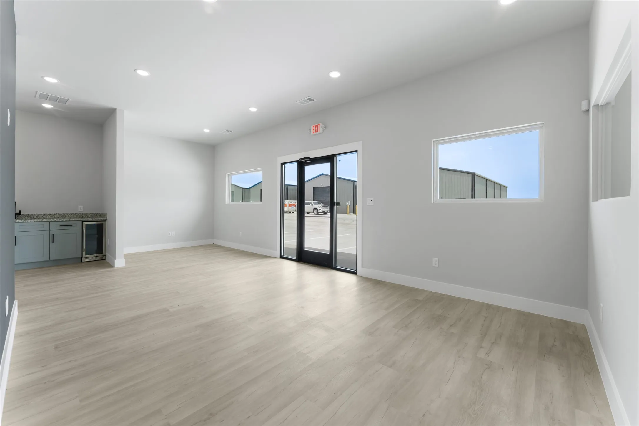 Unfurnished room featuring light hardwood / wood-style flooring and wine cooler