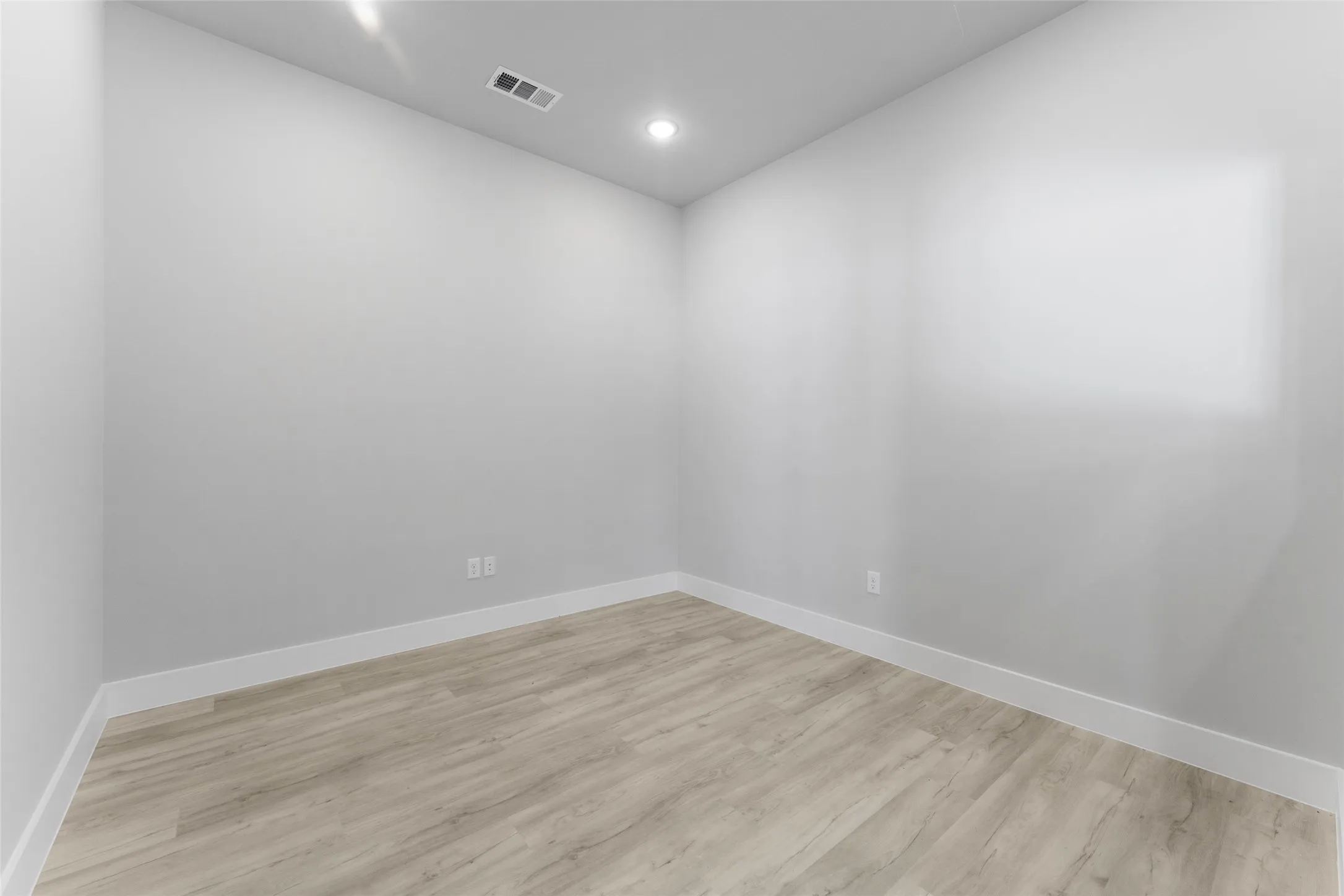 Spare room with light wood-type flooring