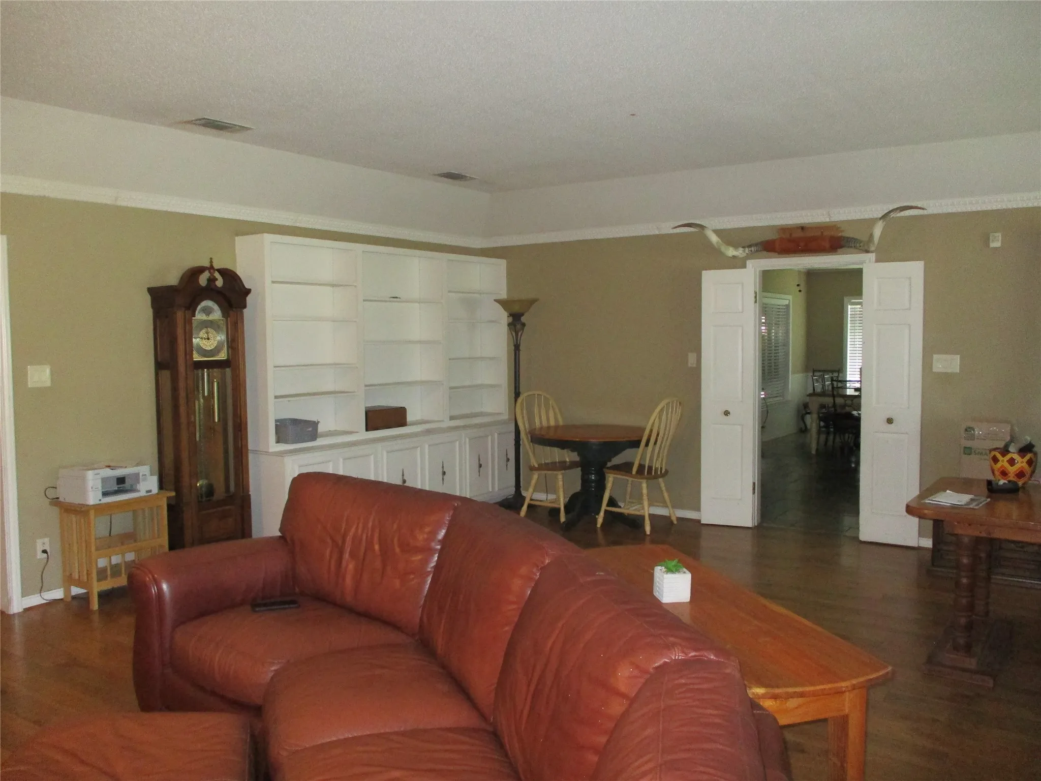 Living room featuring dark wood-type flooring and a textured ceiling