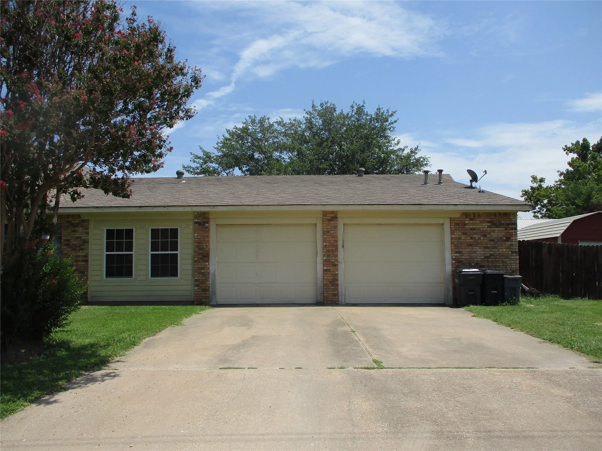 Single story home featuring a garage and a front yard