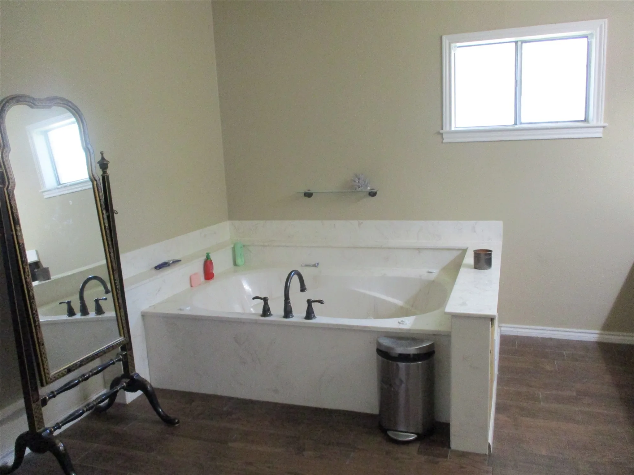 Bathroom with hardwood / wood-style flooring and a bathtub