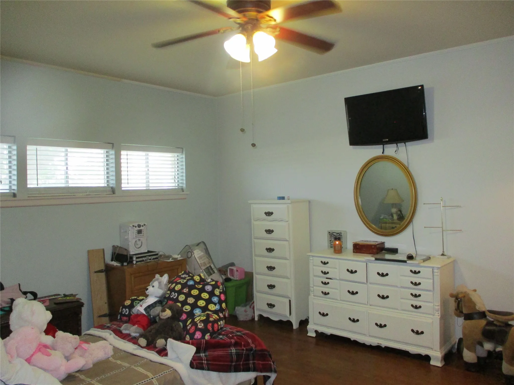 Bedroom with dark hardwood / wood-style floors and ceiling fan