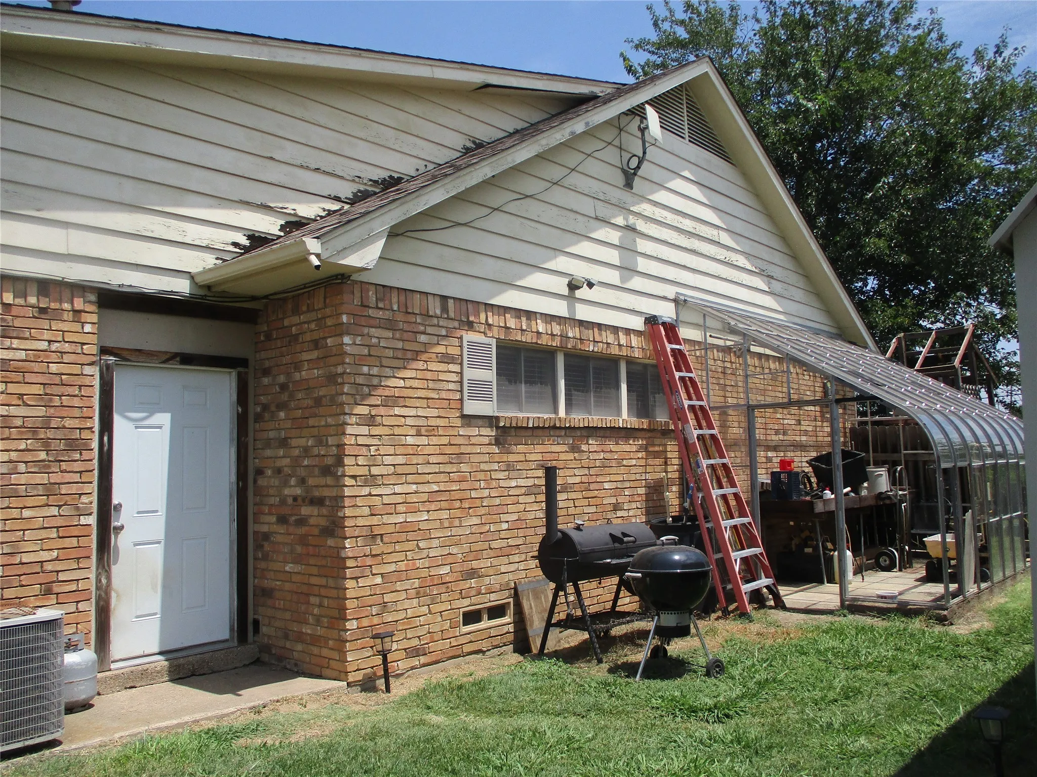 Rear view of house featuring cooling unit