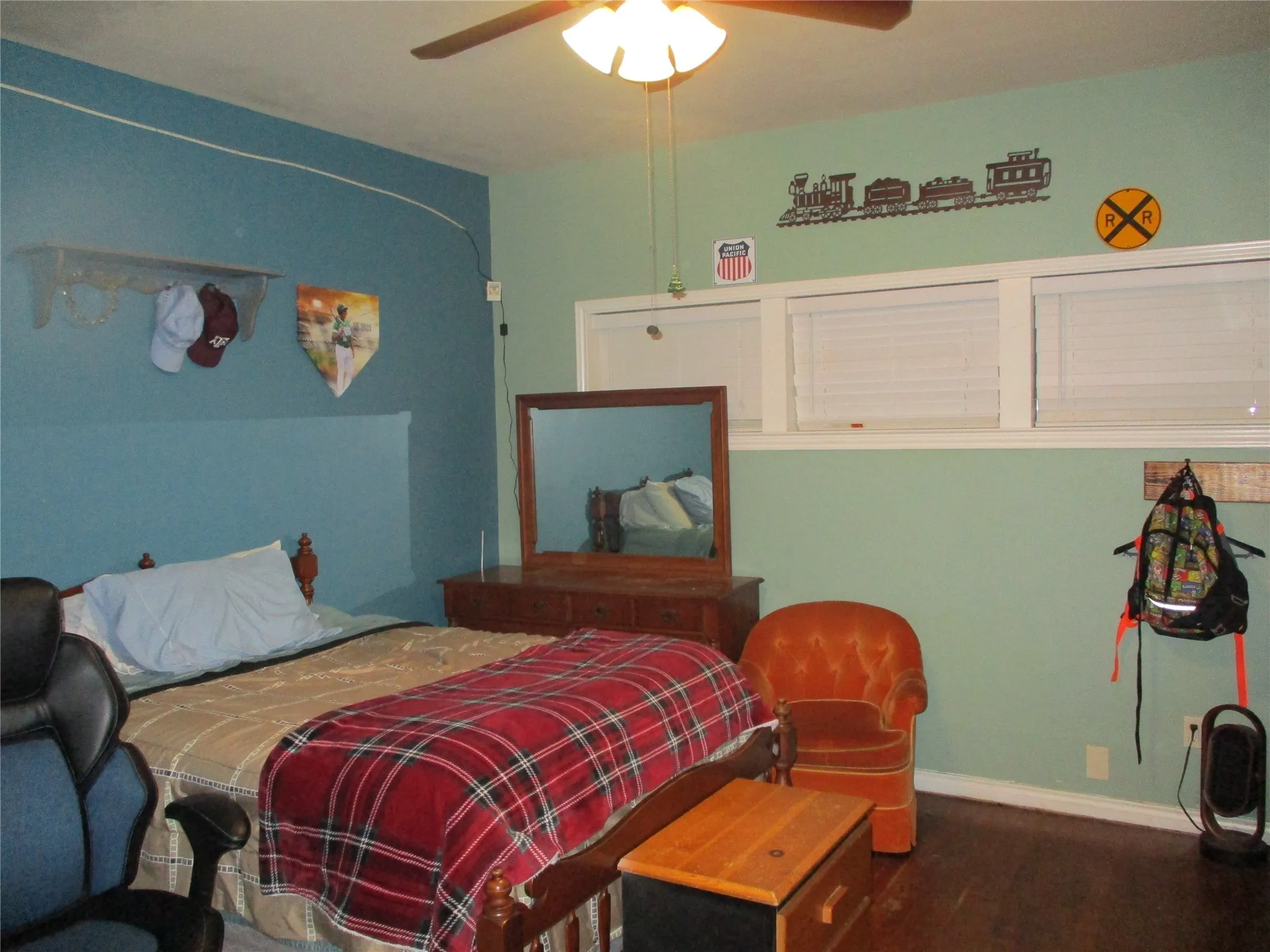 Bedroom featuring ceiling fan and hardwood / wood-style flooring