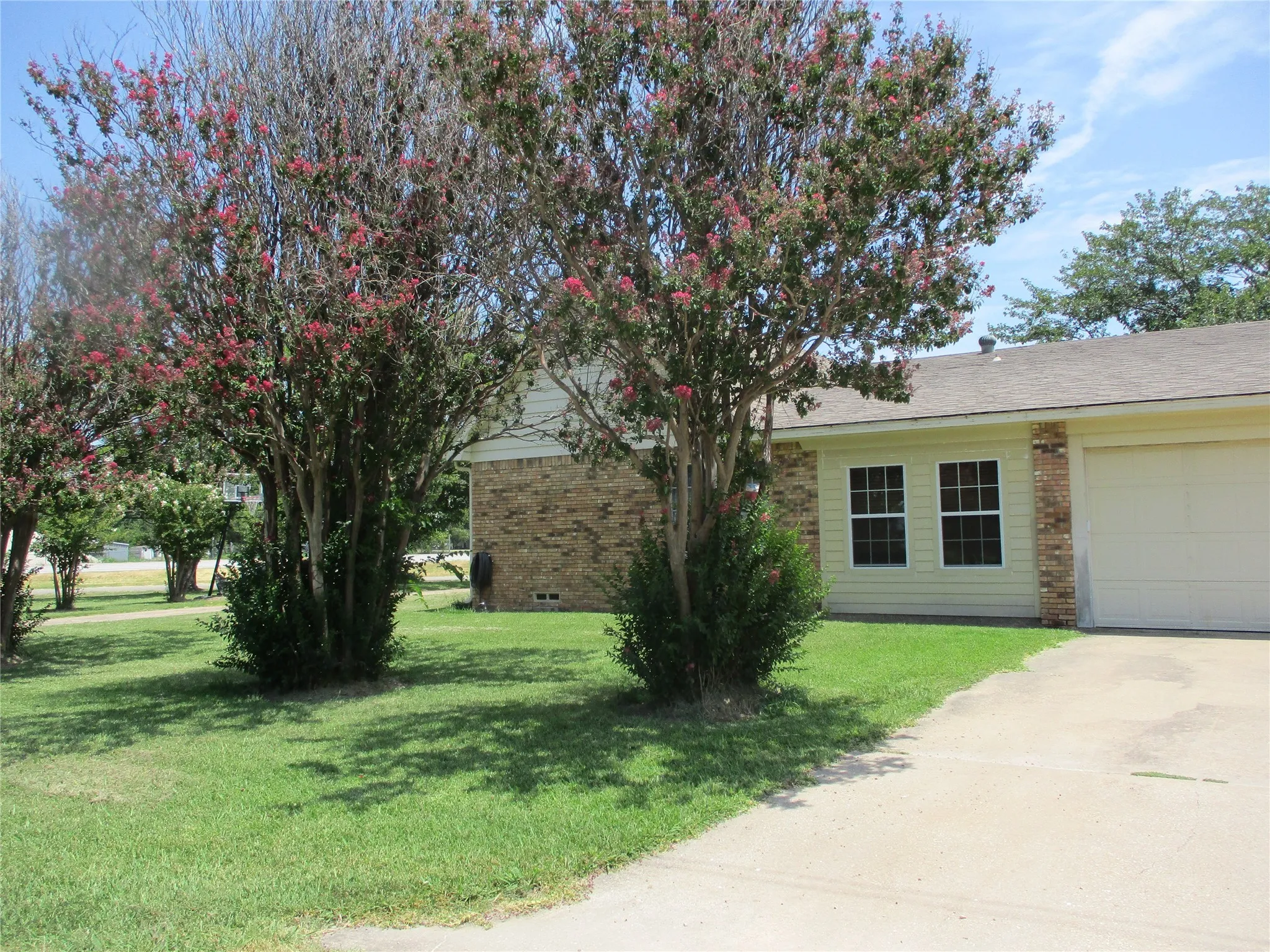 View of front of home with a garage and a front lawn